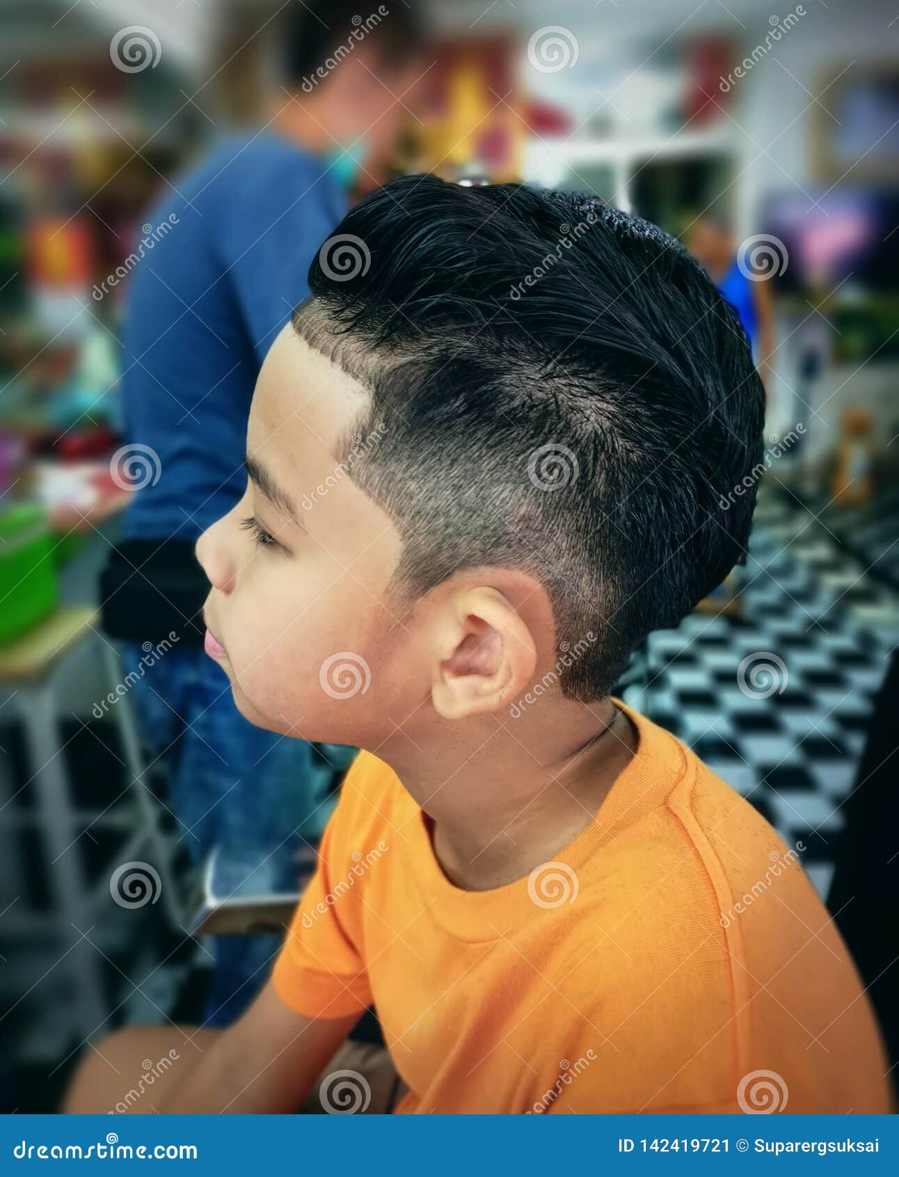 asian boy wearing t shirt getting new hair cut barber shop asian boy wearing casual t shirt getting new hair cut barber shop 142419721