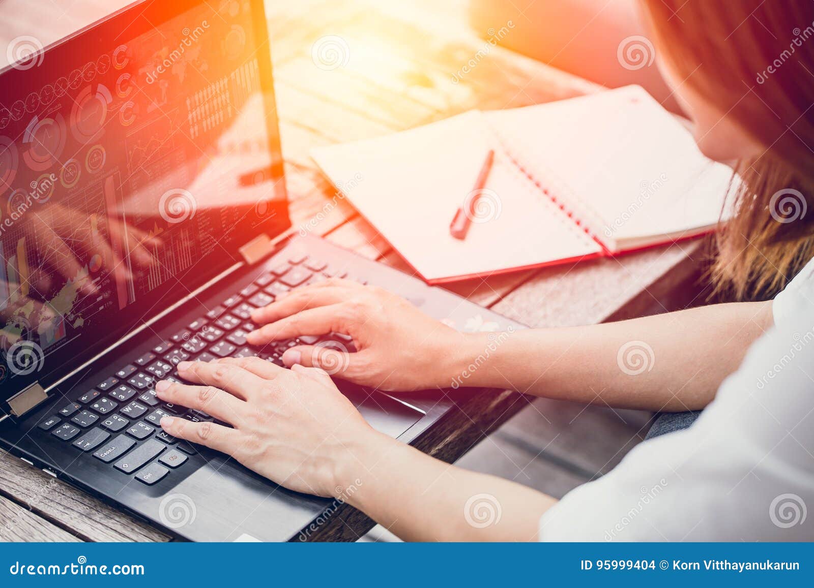 asian business woman work typing on laptop with graph data on screen