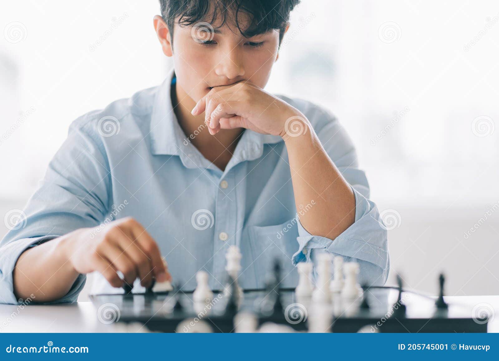 Children's Restraining Hand Thoughtfully Figure Before The Next Chess Move  Stock Photo, Picture and Royalty Free Image. Image 77247675.