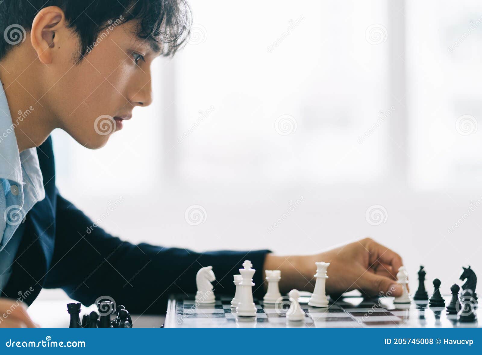 Handsome Male Model Considers His Next Chess Move Stock Photo