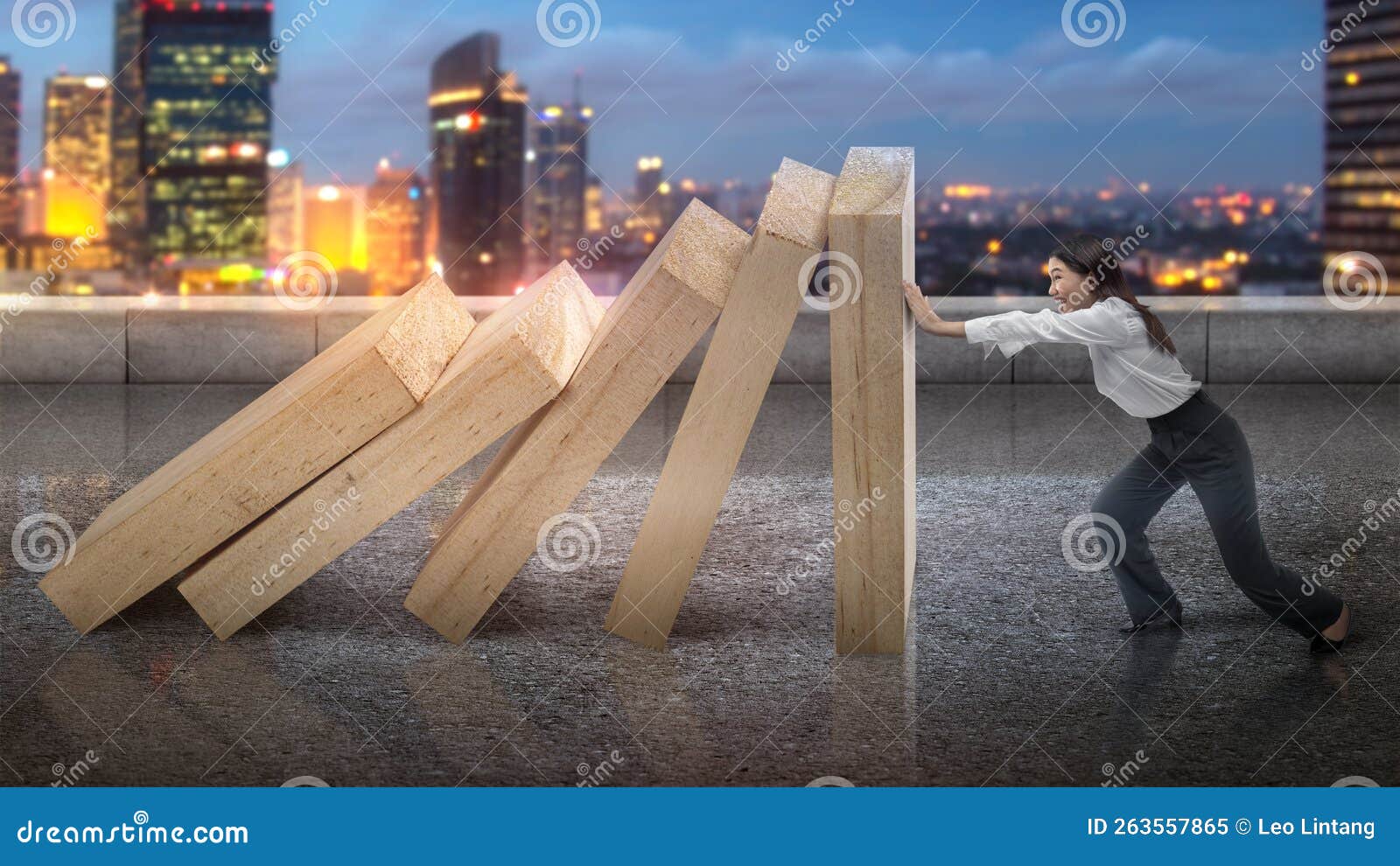 asian businesswoman holds back the topple wooden block