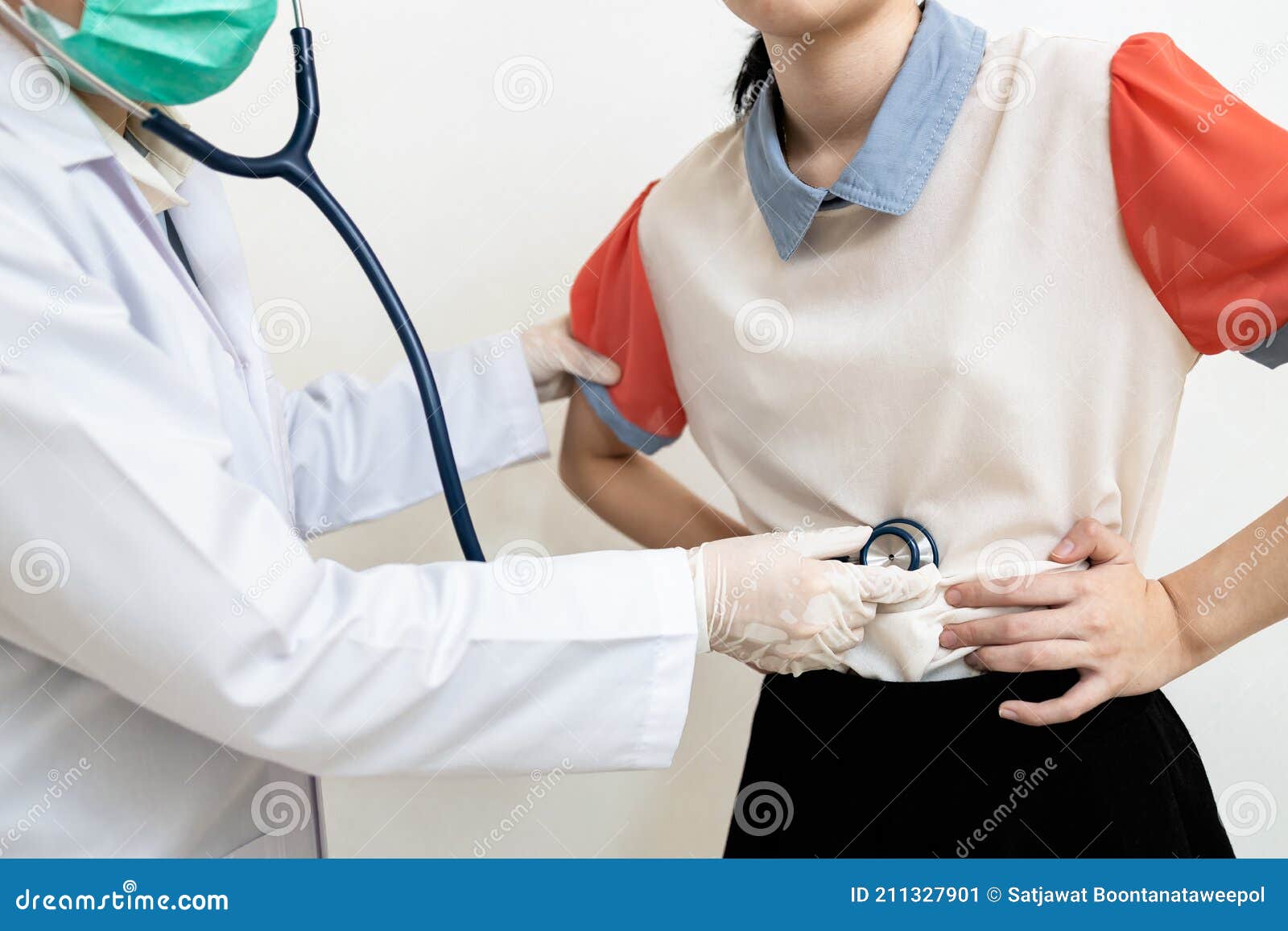 asian child girl with flatulence,bloated stomach checking the abdomen,physical examination,doctor using a stethoscope,listen to