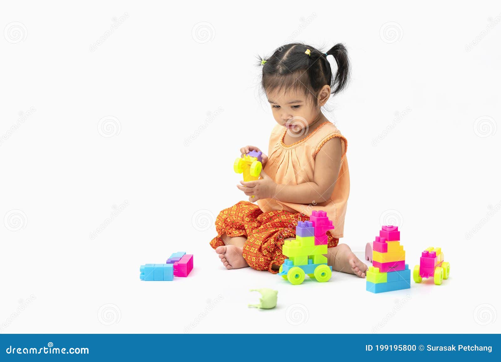 Asian Child Girl In Thai Traditional Dress Sit And Play Colorful