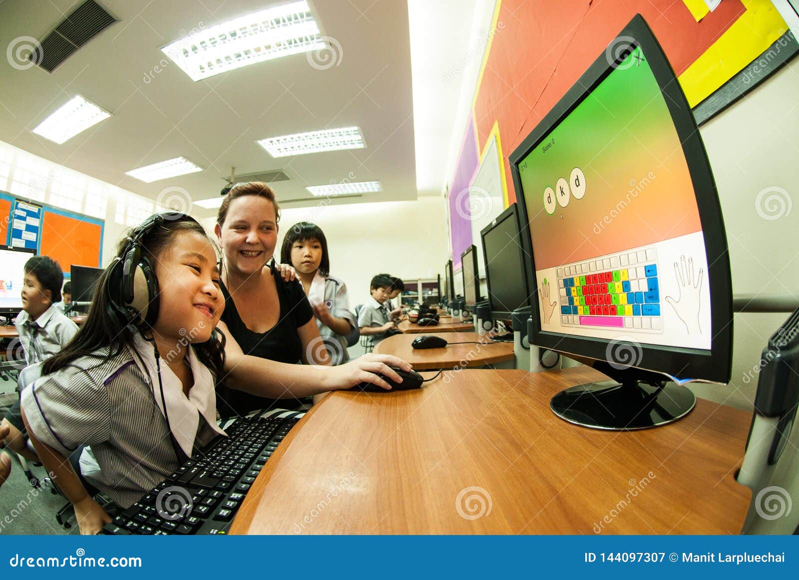 Asian Elementary Child Learning To Use Computer In
