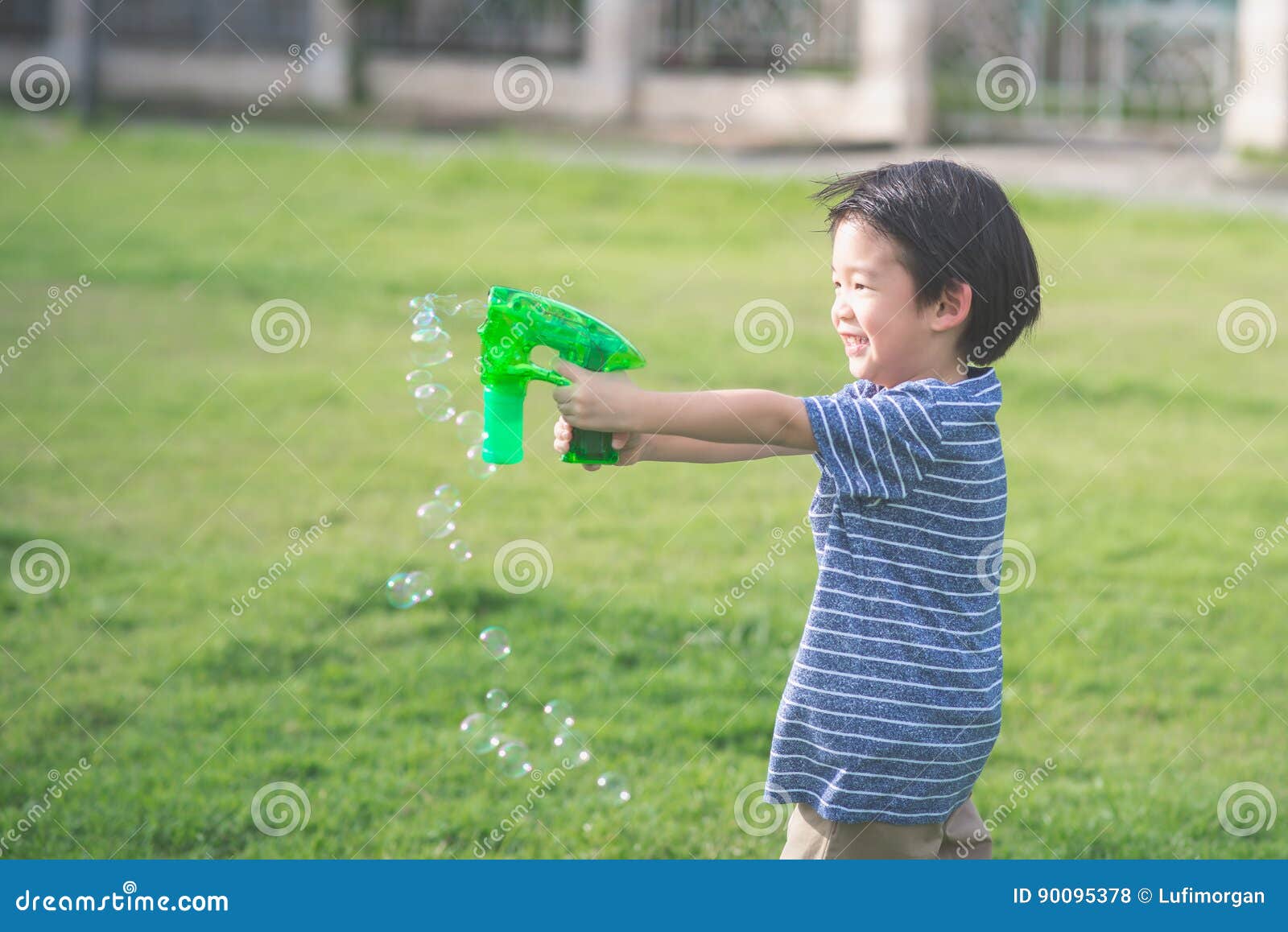 Asian Child Shooting Bubbles from Bubble Gun Stock Photo Image of