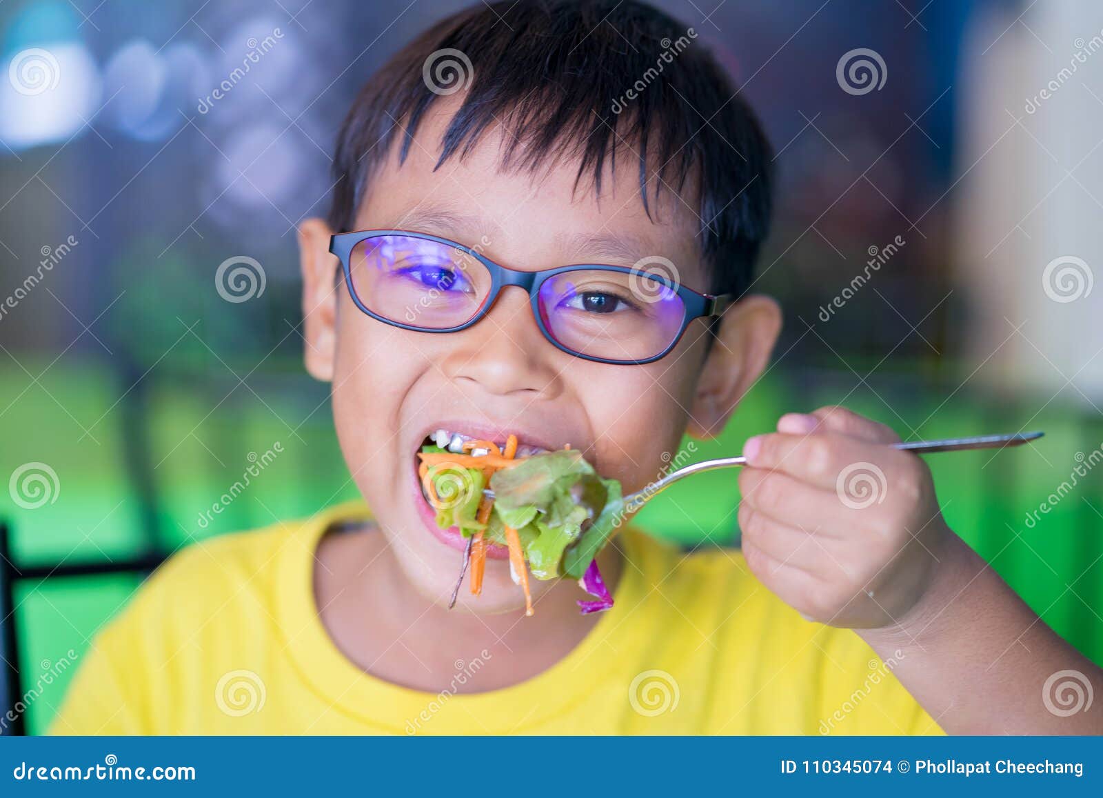 asian children wear glasses with blue light blocking and eating