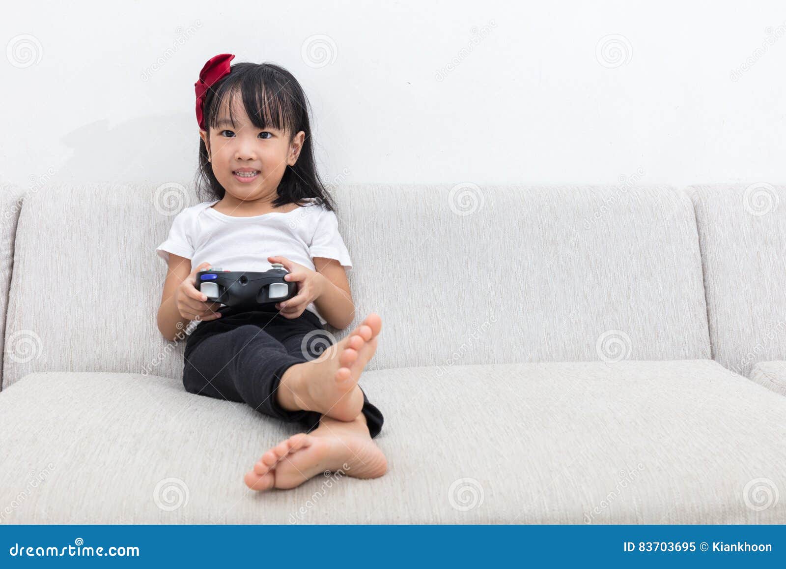 Happy Couple Sitting on the Sofa Playing Video Games, Using Controllers.  Competitive Girlfriend and Boyfriend in Love have Fun Playing in Online  Video Games at Home Together. Close-up Focus on Hands Stock