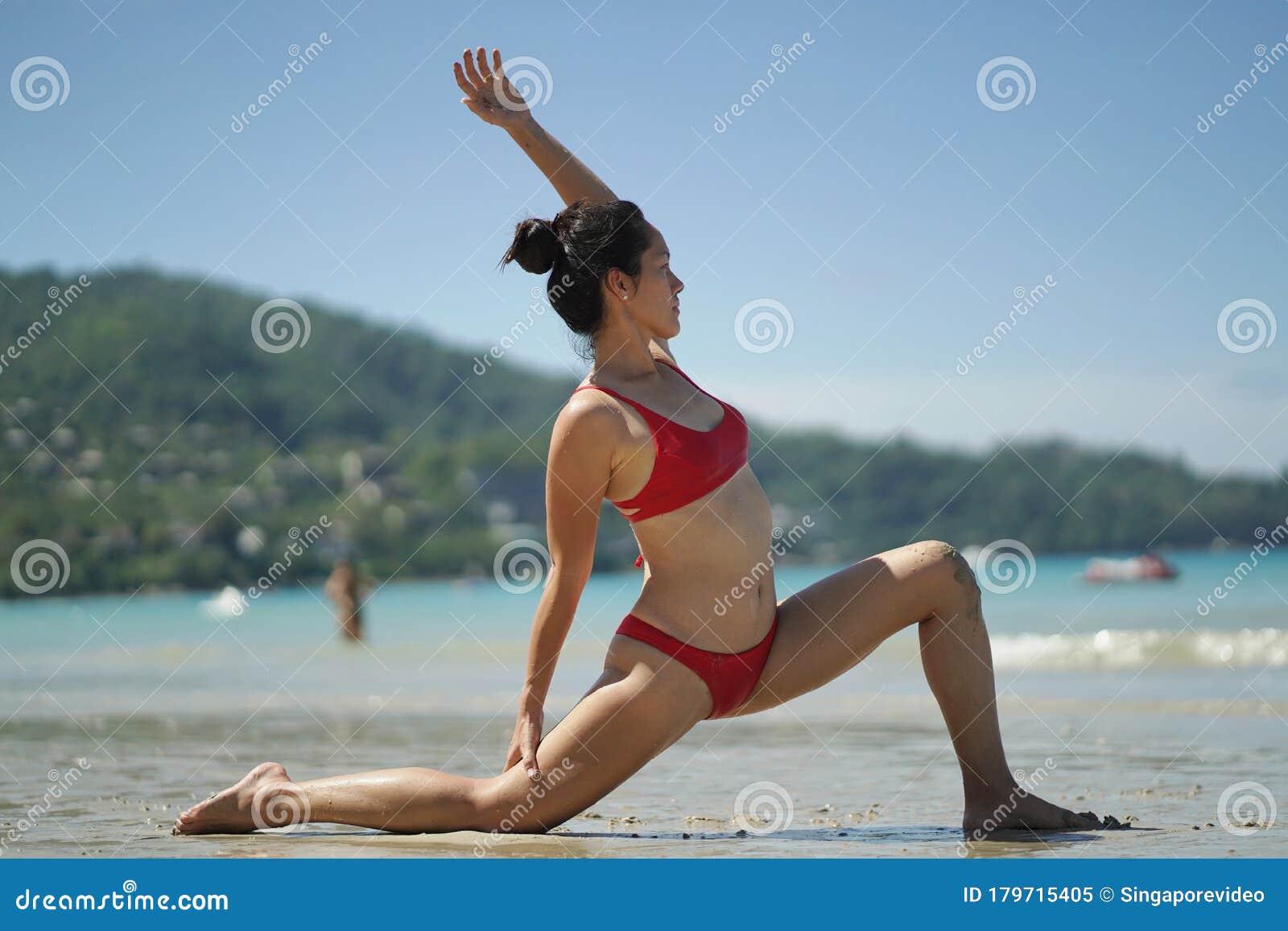 Asian Chinese Woman in Various Yoga Poses at the Beach Stock Photo