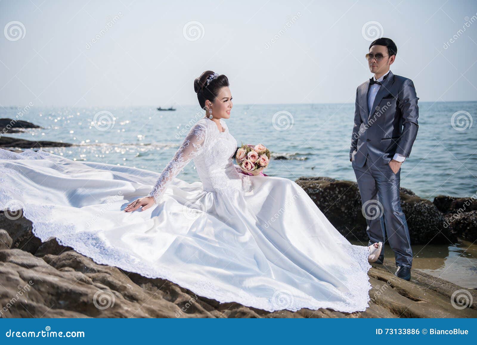 Asian Couple Wearing Wedding Dress And Suit Stock Photo