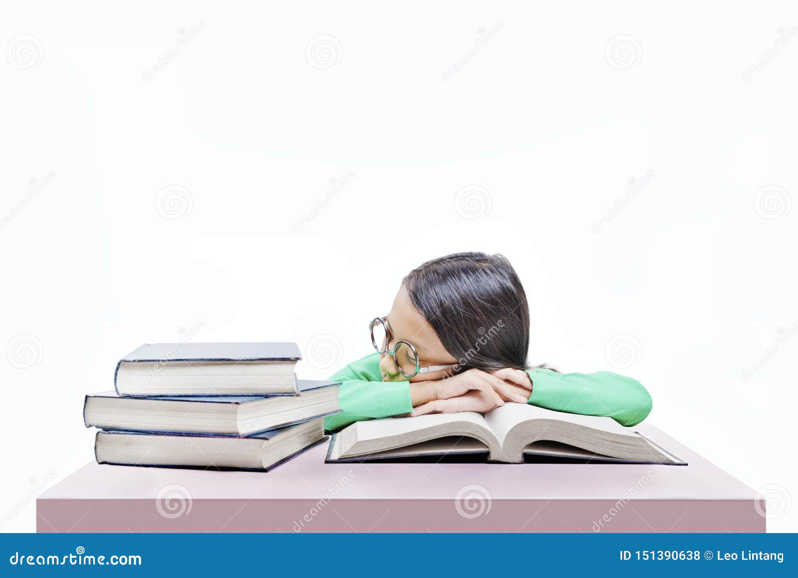 Asian Cute Girl With Glasses Fall Asleep On Book On The Desk Stock