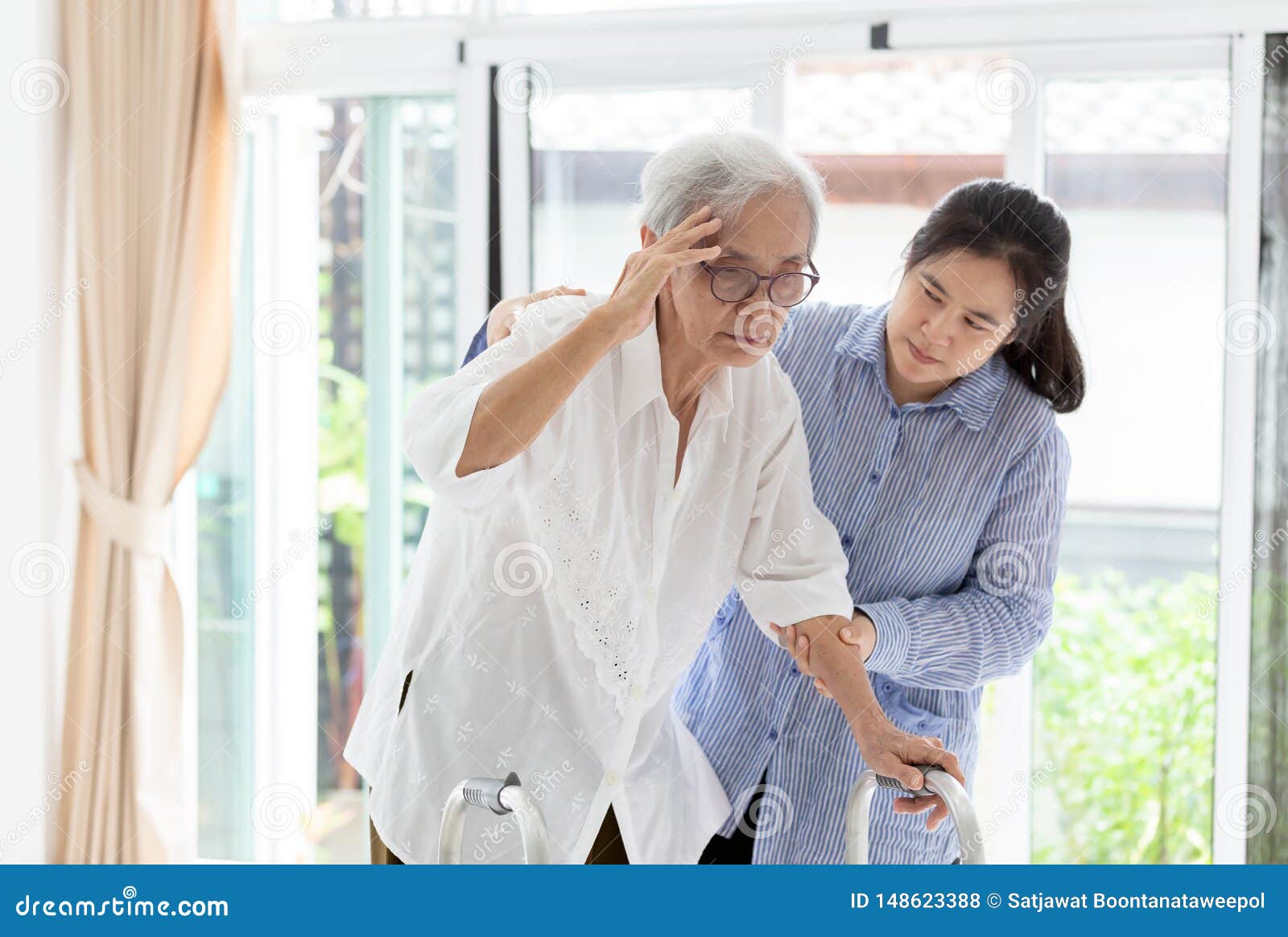 asian daughter or care assistant helping support senior woman or mother,communicates the symptoms of vertigo;dizziness;migraine;