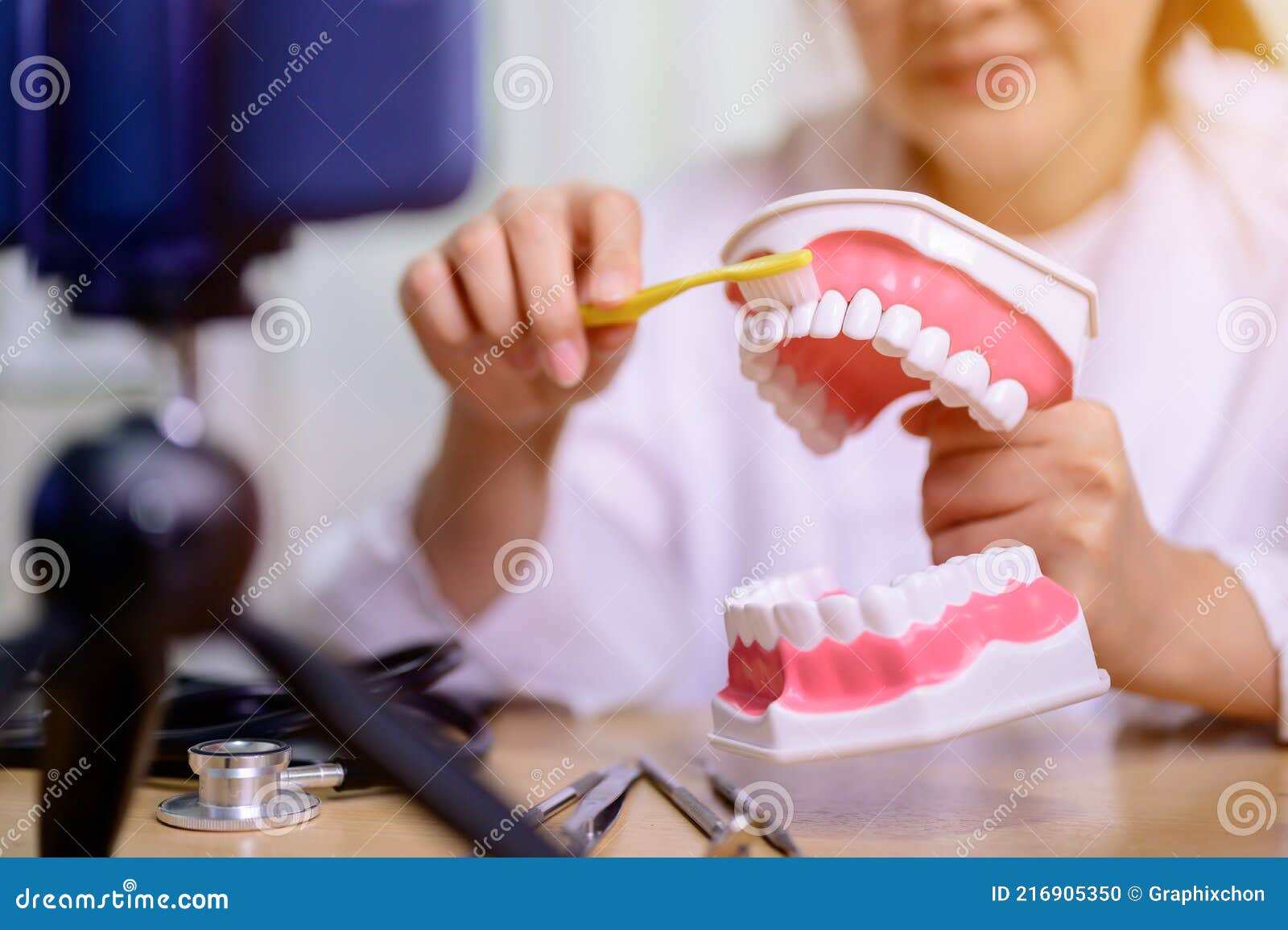 asian dentist woman working online at home. recording blog video for tutorial instructional brushing teeth clean.