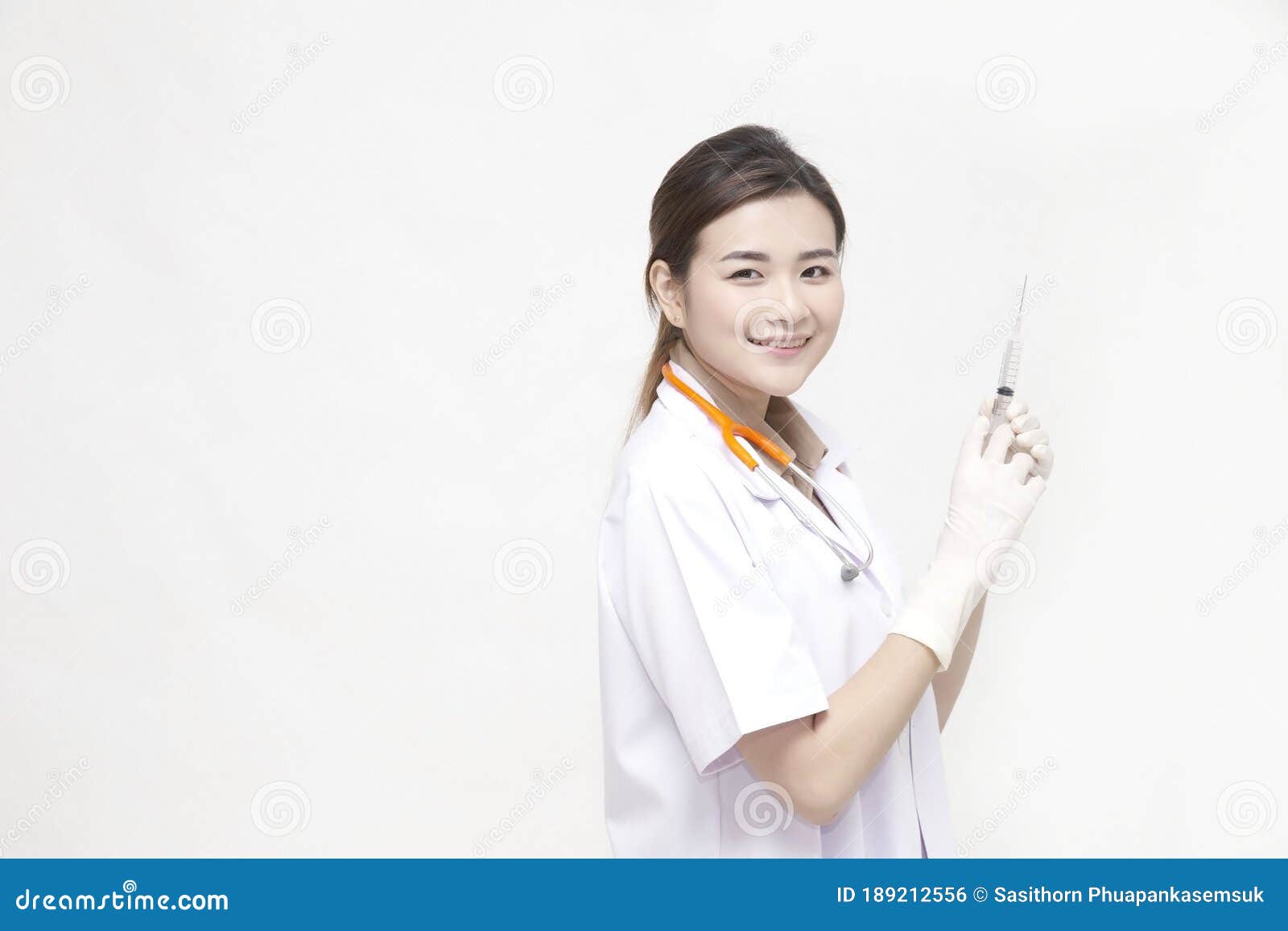 doctor with smile which preparation syringe and  needle vaccination for a operation  on white background