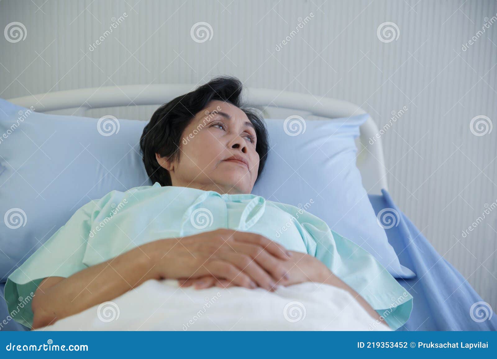 asian elderly woman lying on bed with anxious and worried expression face at hospital