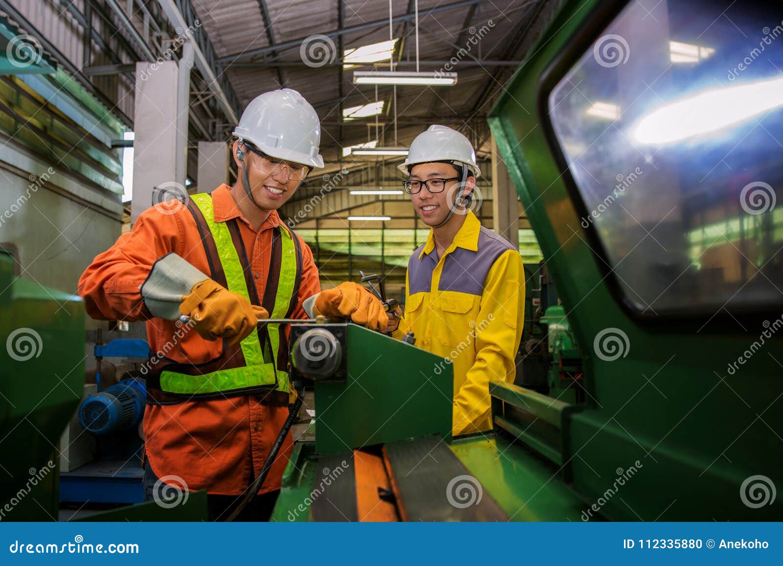 Asian Engineer and Worker Setting Machine for Process Metal Job