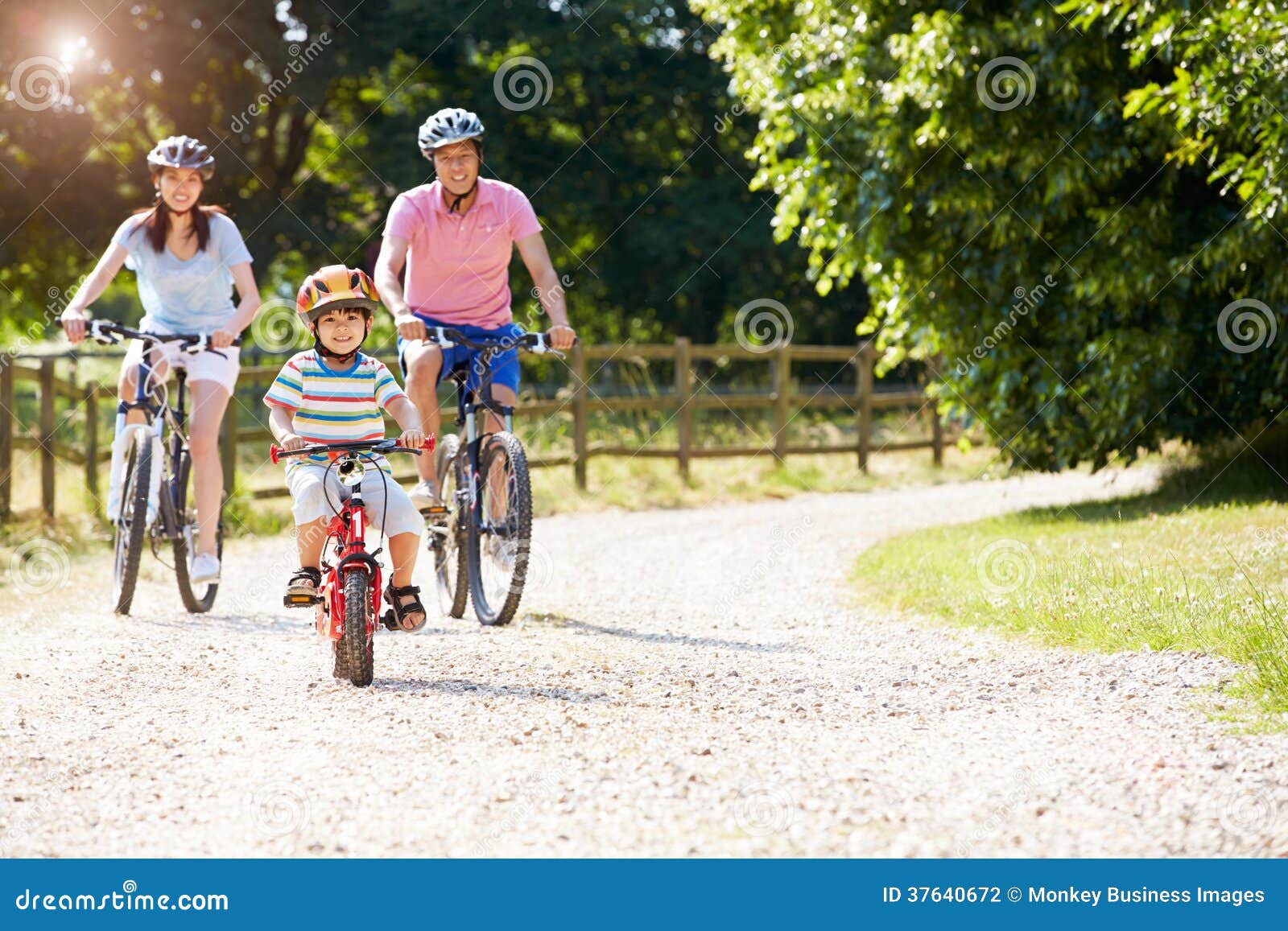 asian family on cycle ride in countryside