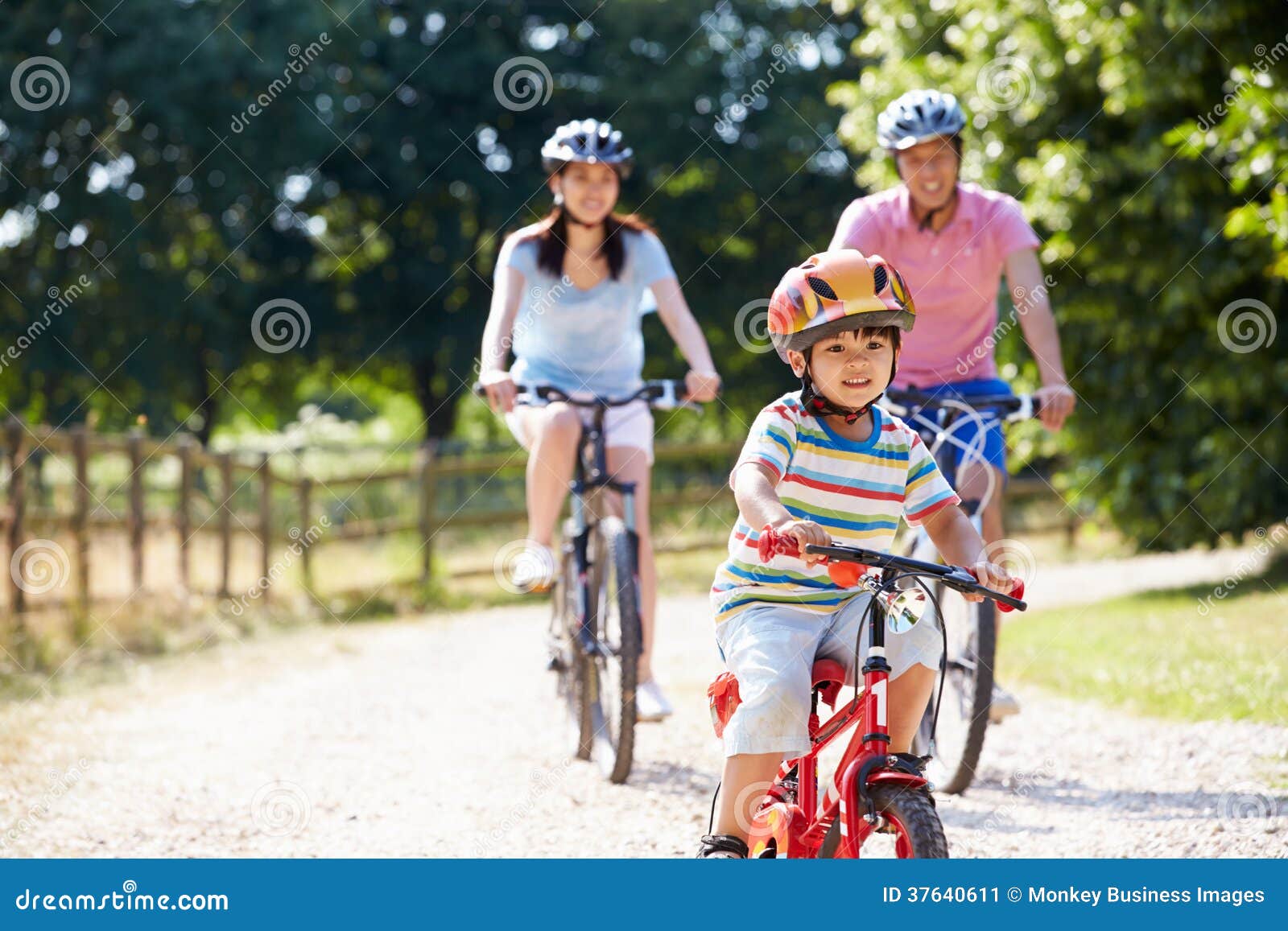 asian family on cycle ride in countryside