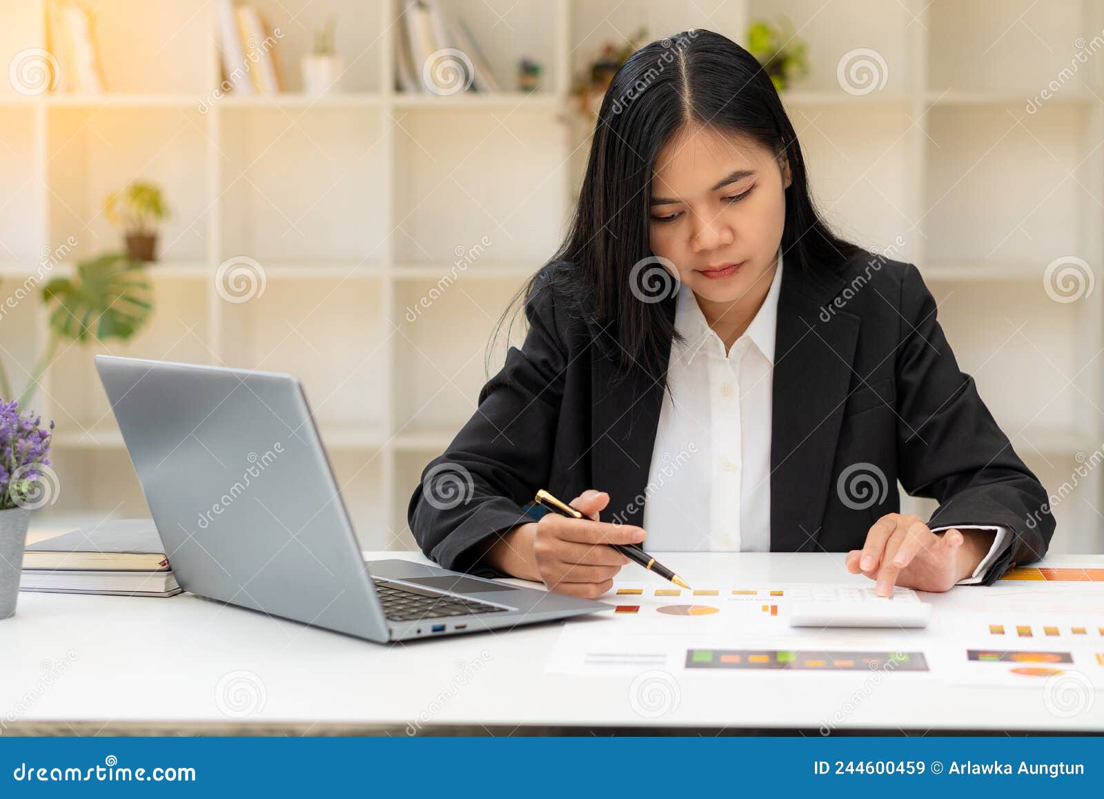 Asian Female Accountant Or Banker Calculating Savings Finance And Economy Concepts Via Laptop
