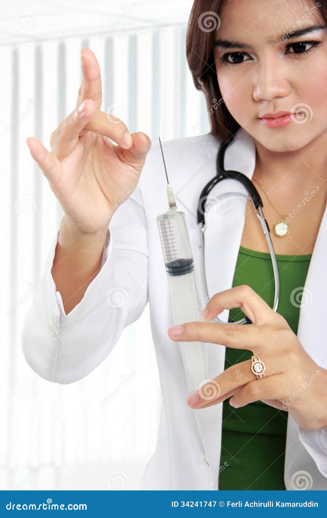 Asian Female Doctor's Wearing A White Coat And Stethoscope Holdi ...