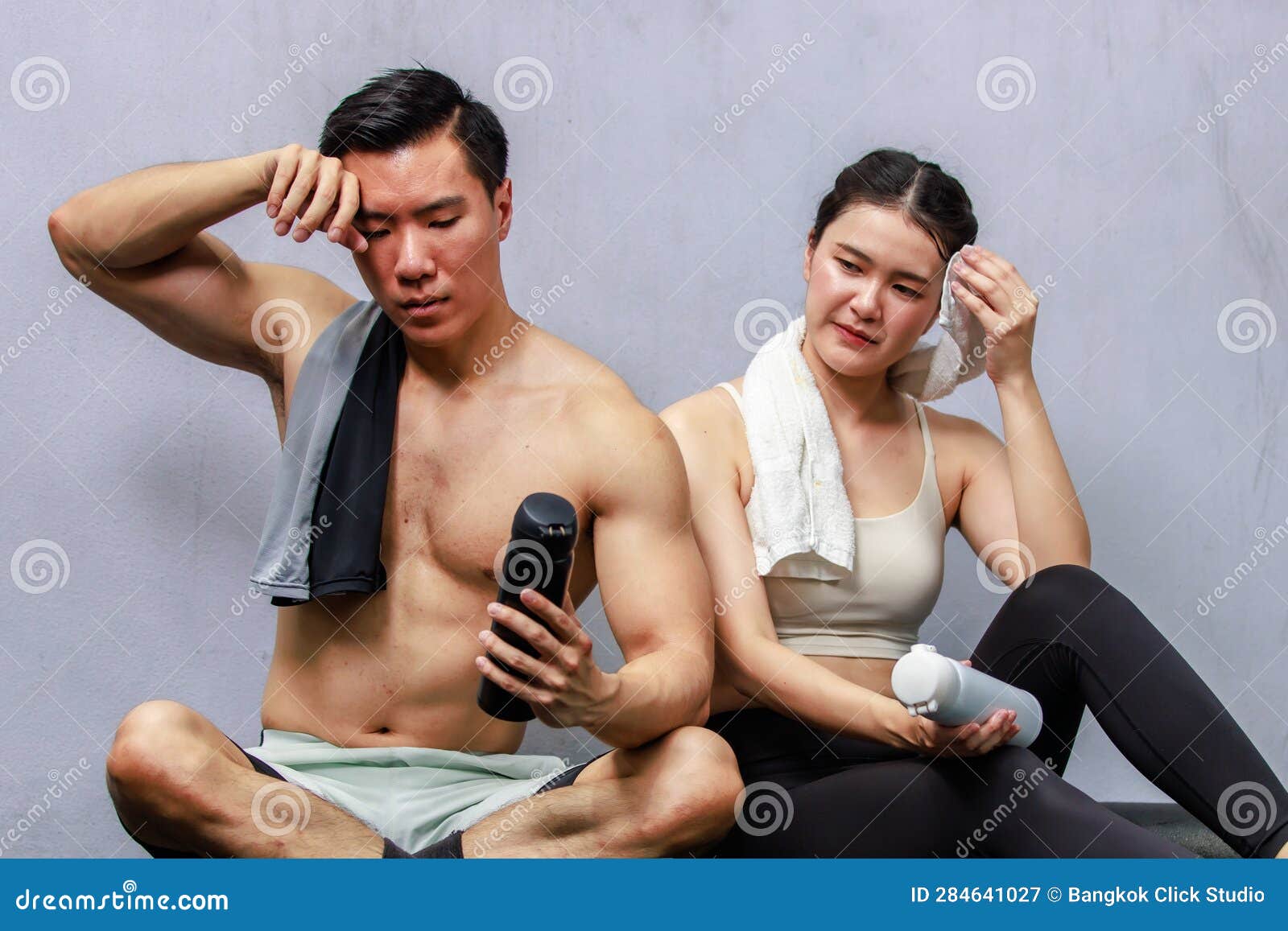 Asian Fit Strong Handsome Shirtless Male Fitness Model with Young Female Athlete Friend in Sport Bra Sitting Taking Break Drink Stock Image picture