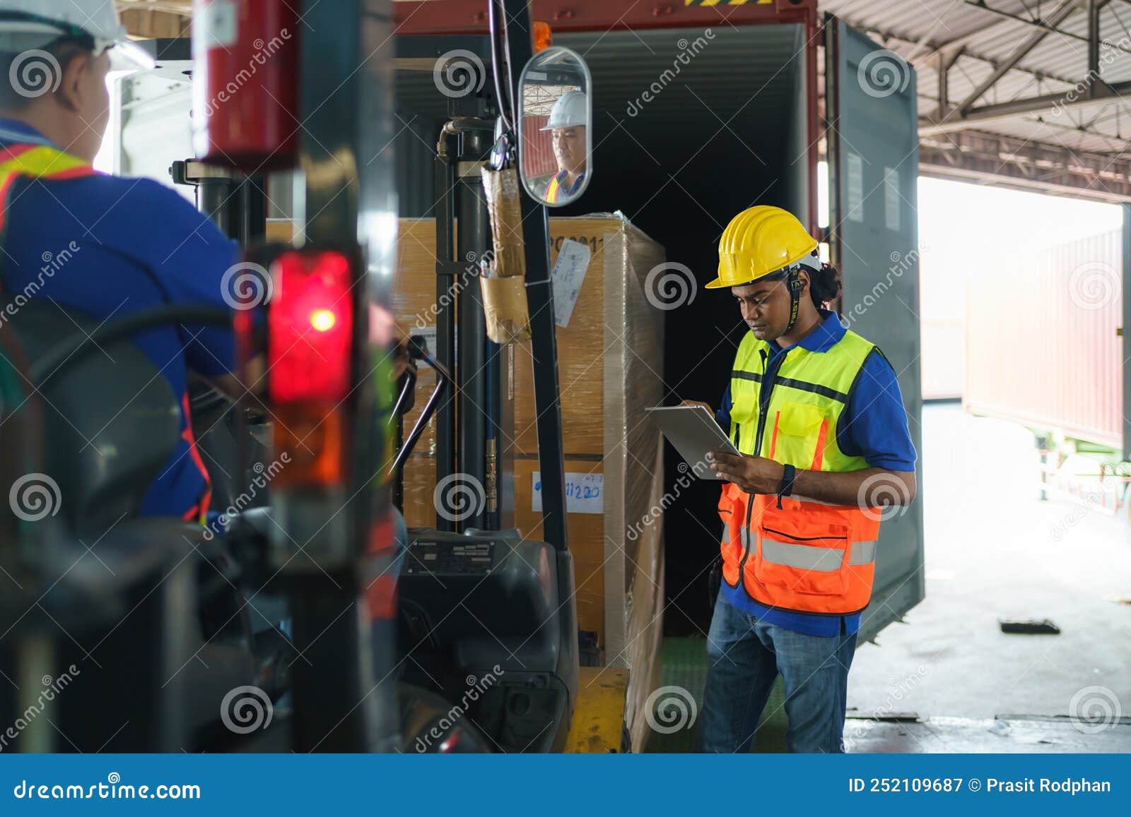 Asian Forklift Driver Loading a Shipping Cargo Container with a Full