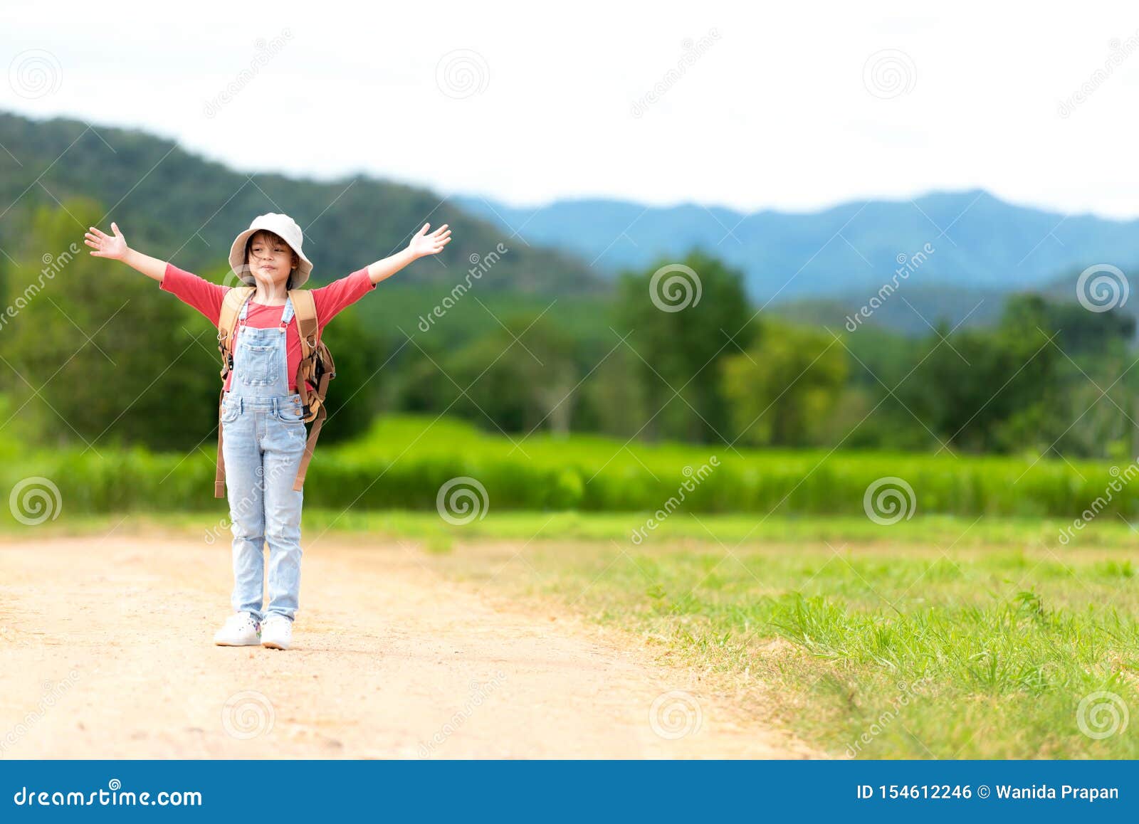 asian girl children raise arms and standing see the outdoors, adventure and tourism for destination and leisure trips with mountai