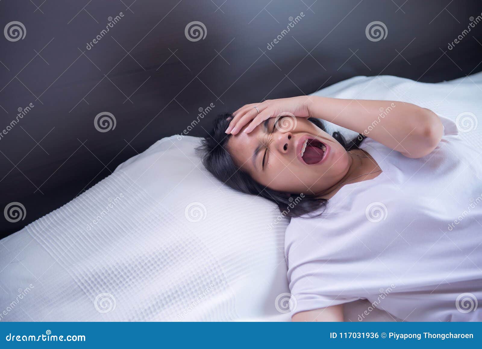 asian girl yawning on her bed and tired sleepy,symptoms and sleepiness
