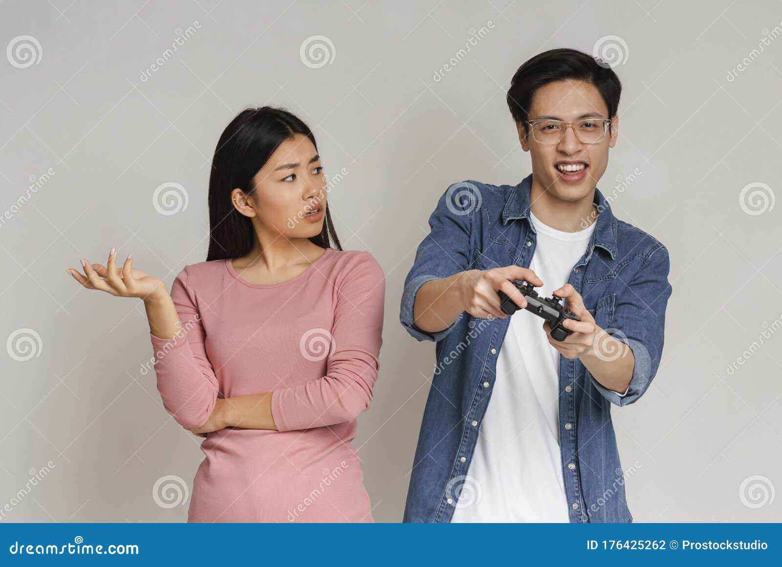 Man Playing Video Games At Home And His Girlfriend Bored Beside Looking At  Him Stock Photo, Picture and Royalty Free Image. Image 52407663.