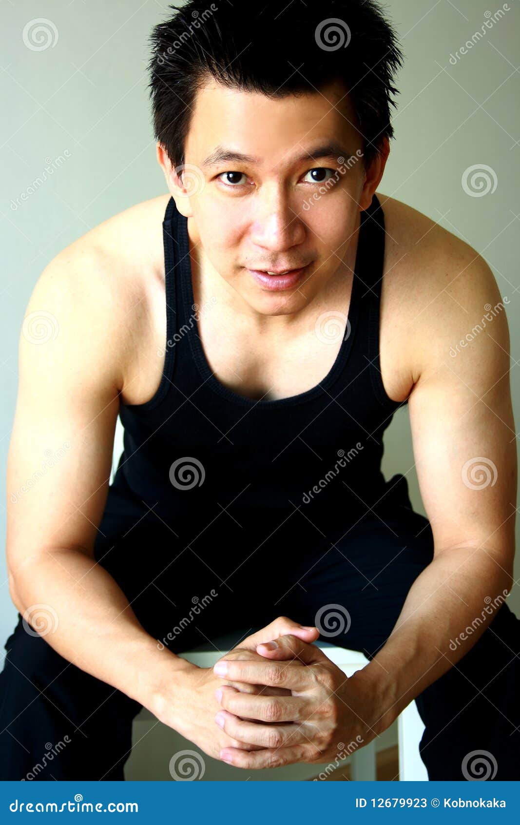 Asian guy sit and smile stock image. Image of health - 12679923