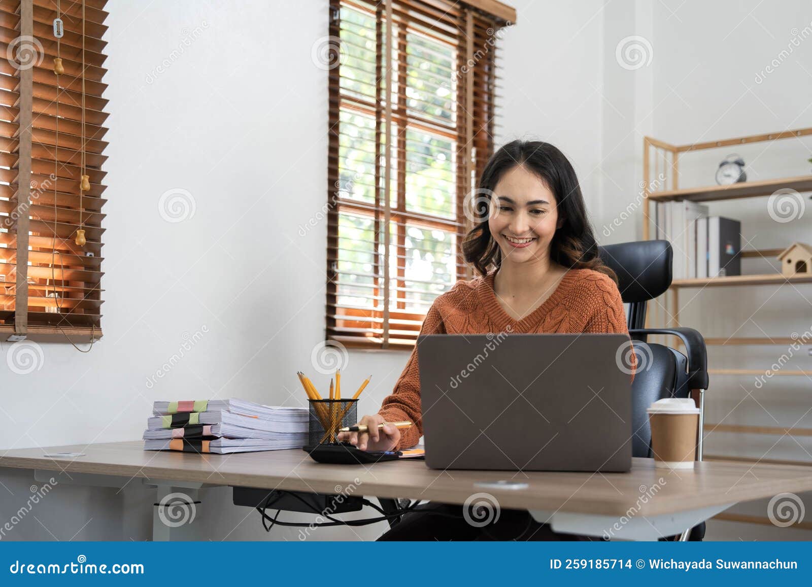 Asian Indian Female Director Working in the Office Sitting at a Desk ...