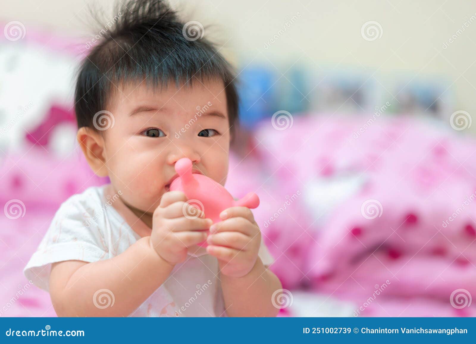 Asian Infant Girl Biting Teether, Baby Growing First Tooth Stock Image