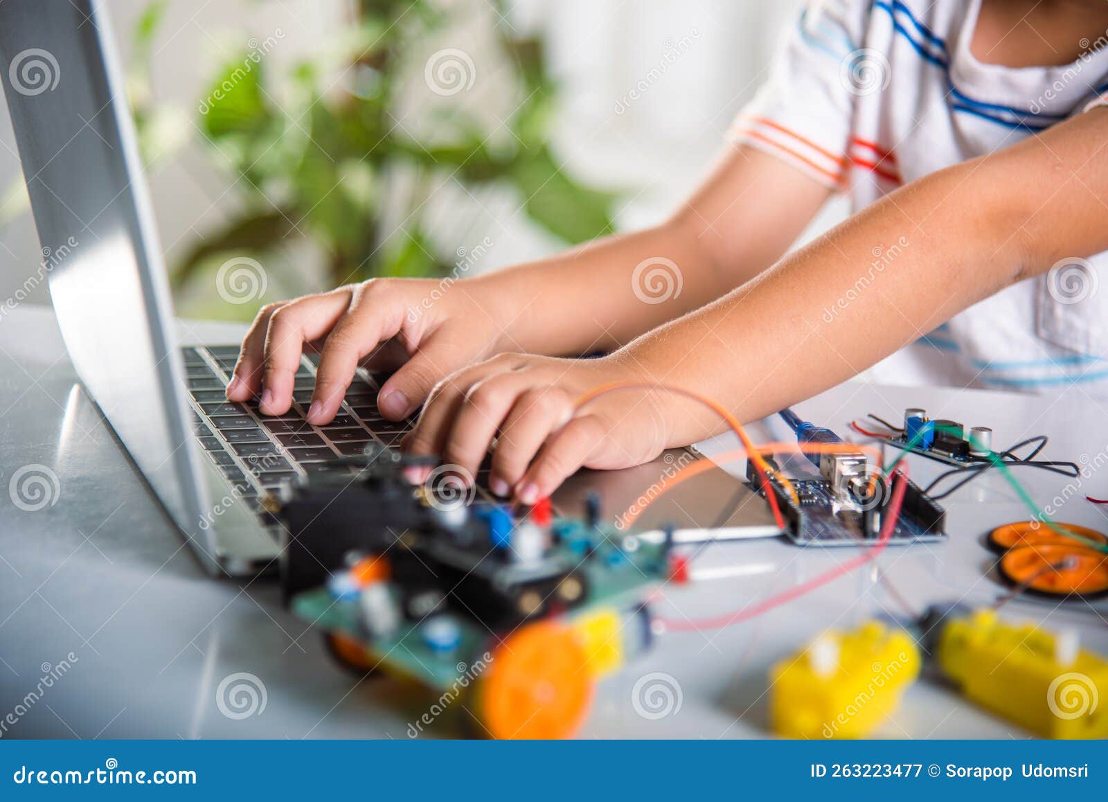Premium Photo Asian little boy programming code to robot machine