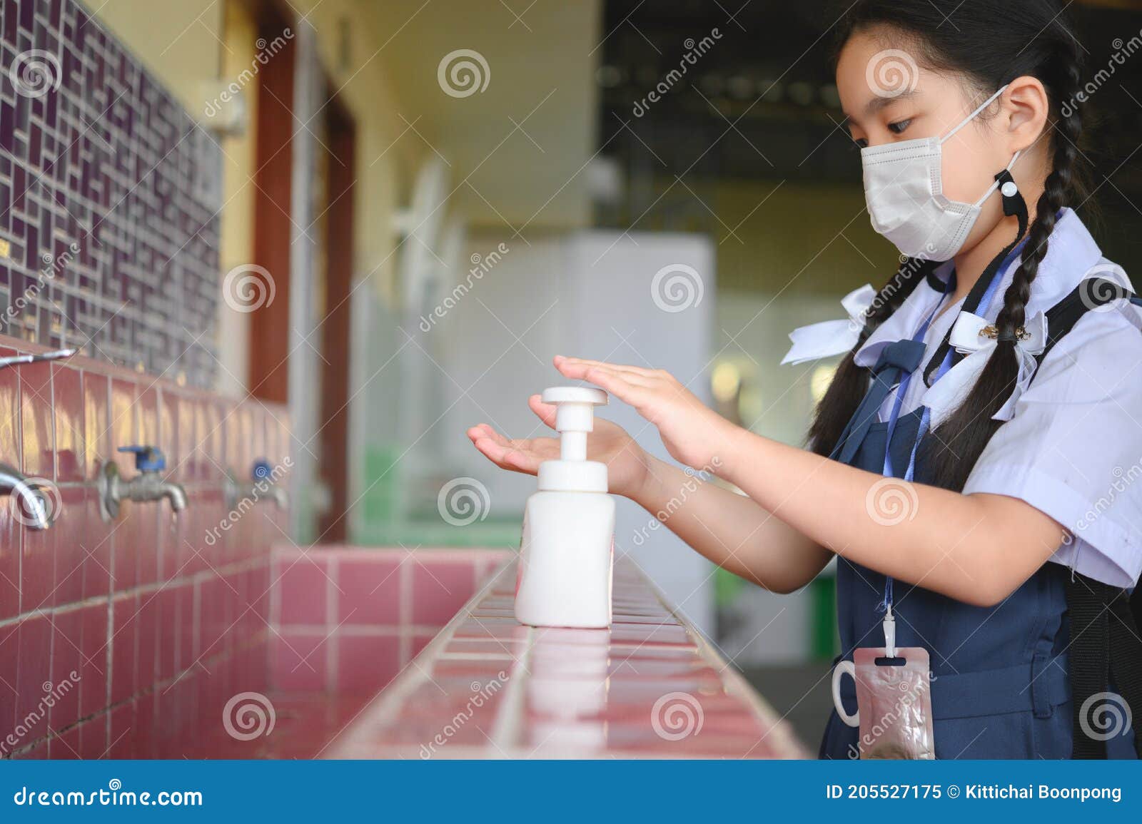 asian kid girl student washing hands and wearing masks at school. reopen school from lockdown. covid-19 coronavirus pandemic. new
