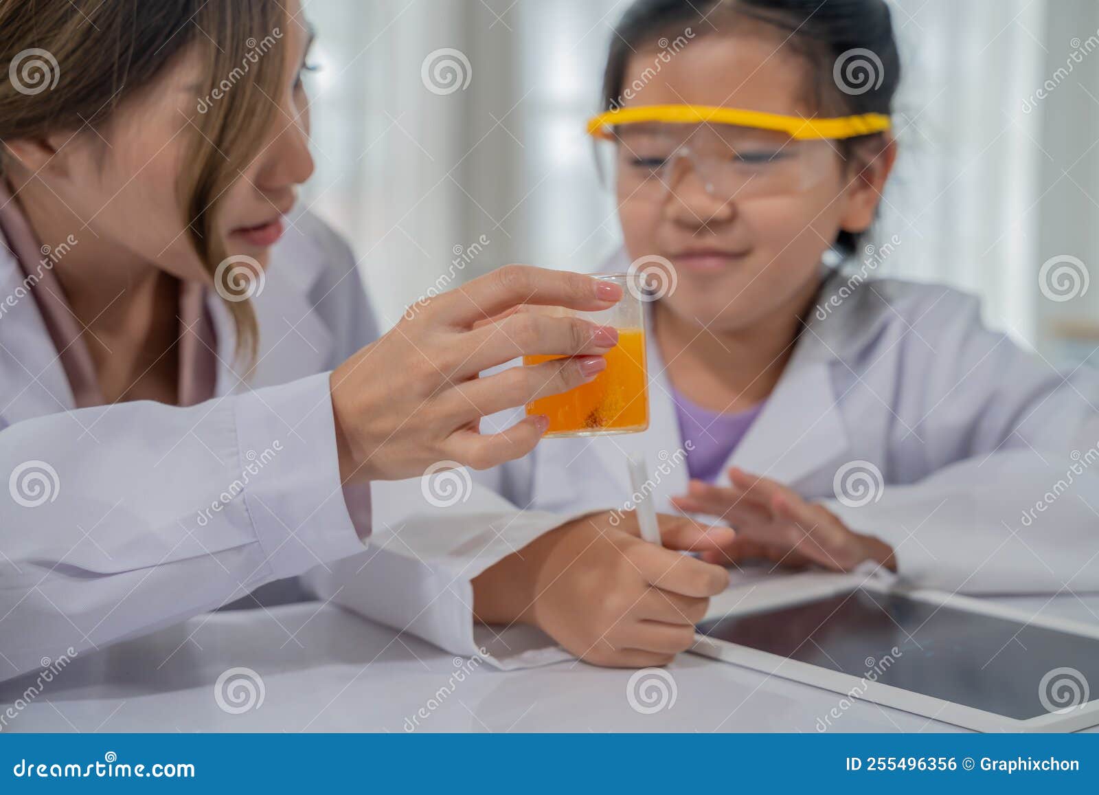 Asian Kid Learning with Scientist in the Laboratory. Physical