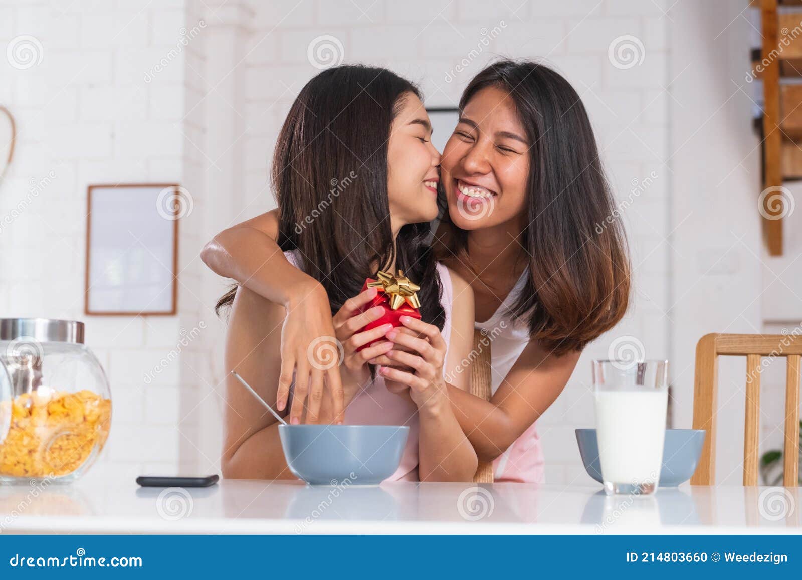 Asian Lesbian Couple Surprise By Giving T For Anniversary Of Love At Kitchen Breakfast Time