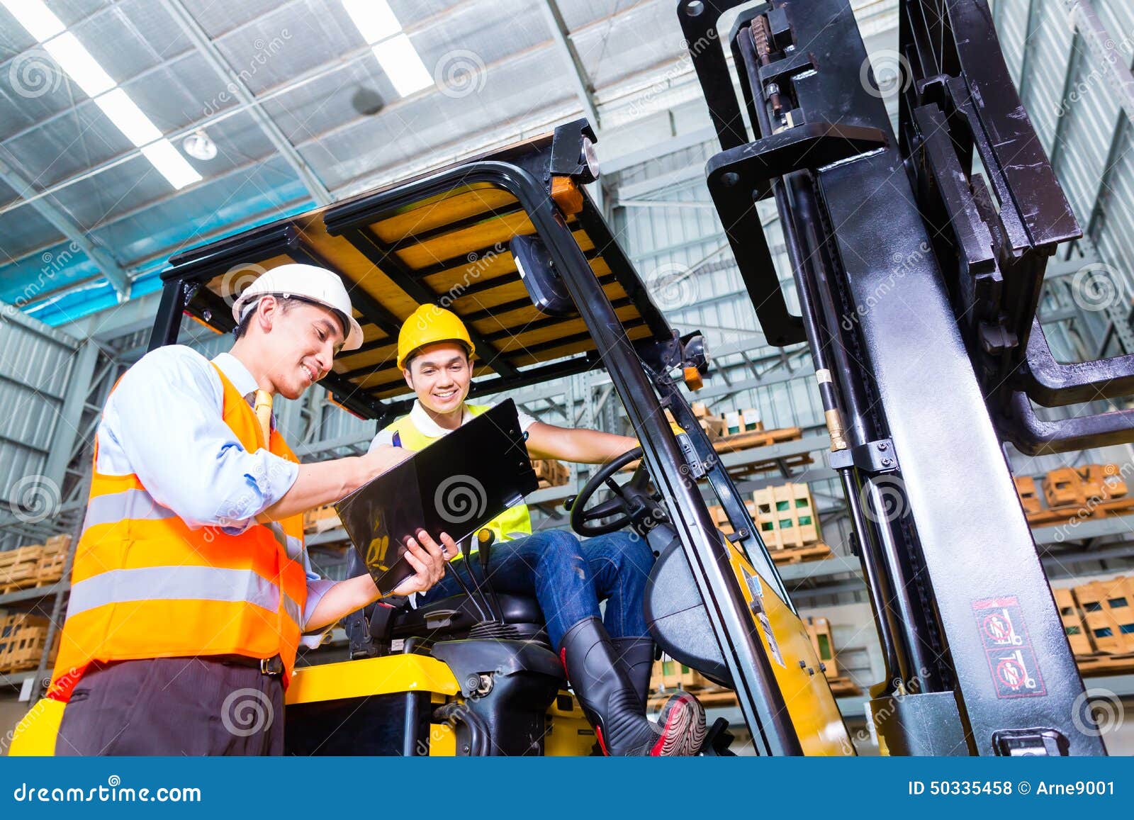 asian lift truck driver and foreman in storage
