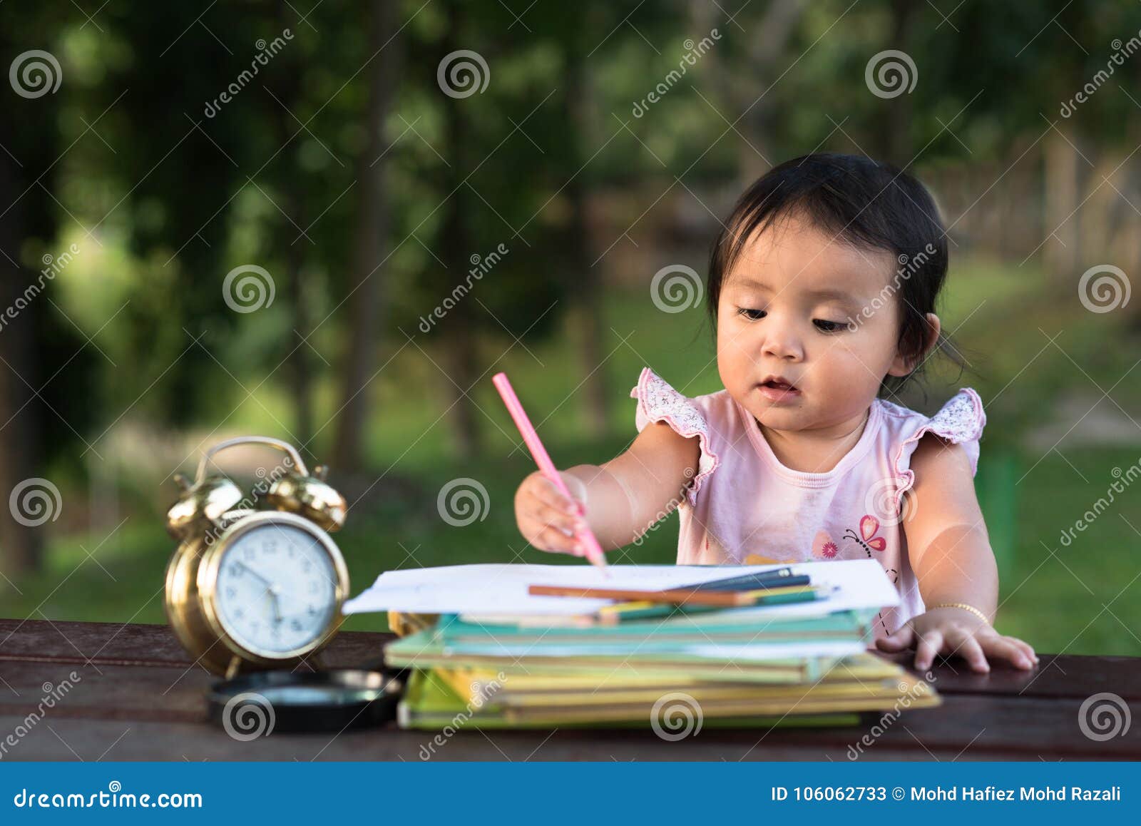 asian little baby toddler drawing at park with copy space