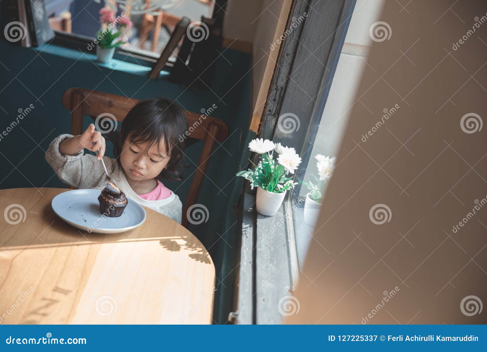 Asian girl eating a cake