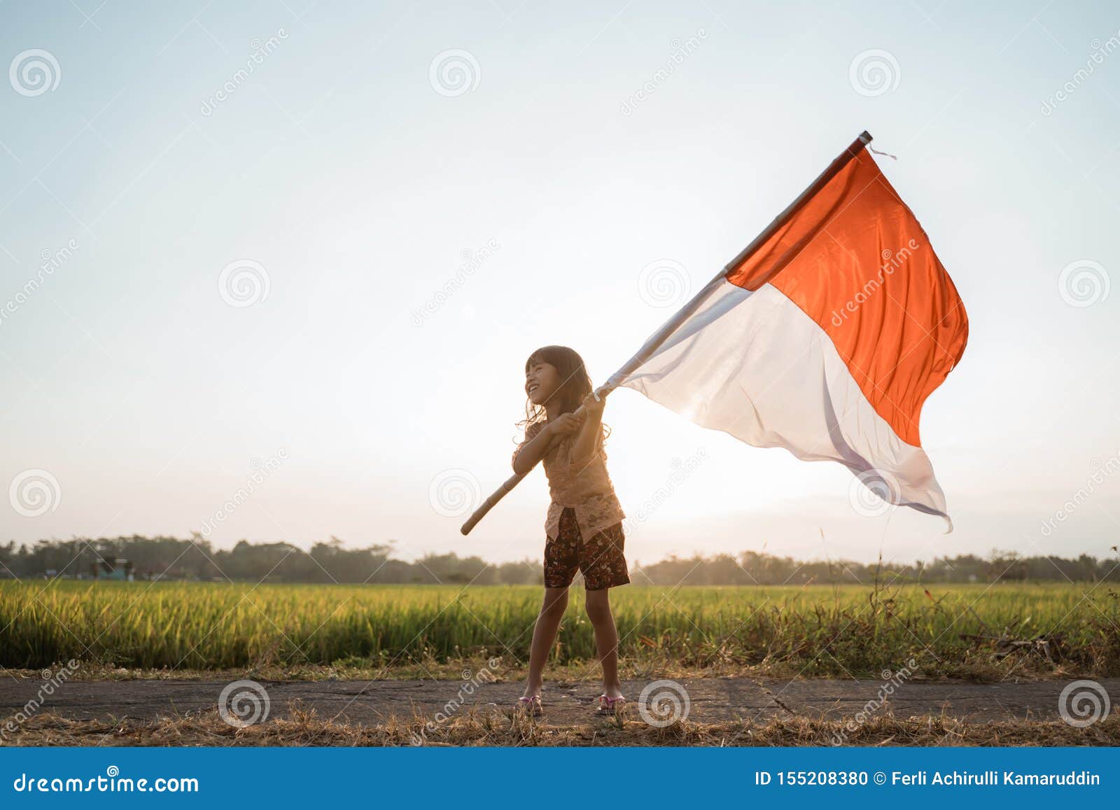 asian little girl flapping indonesian flag