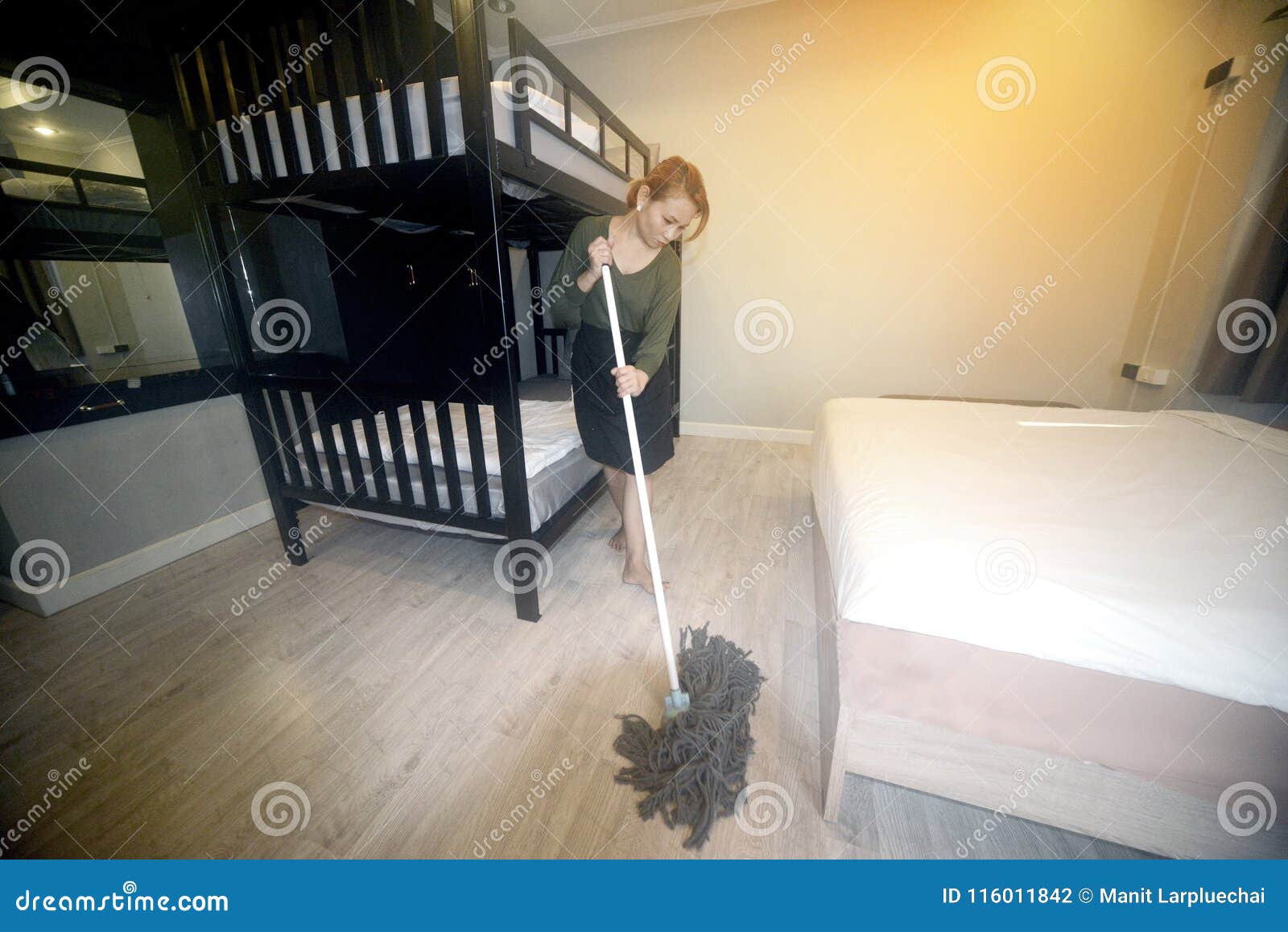 Asian Maid Cleaning Service With Mop Cleaning Floor On A Bedroom