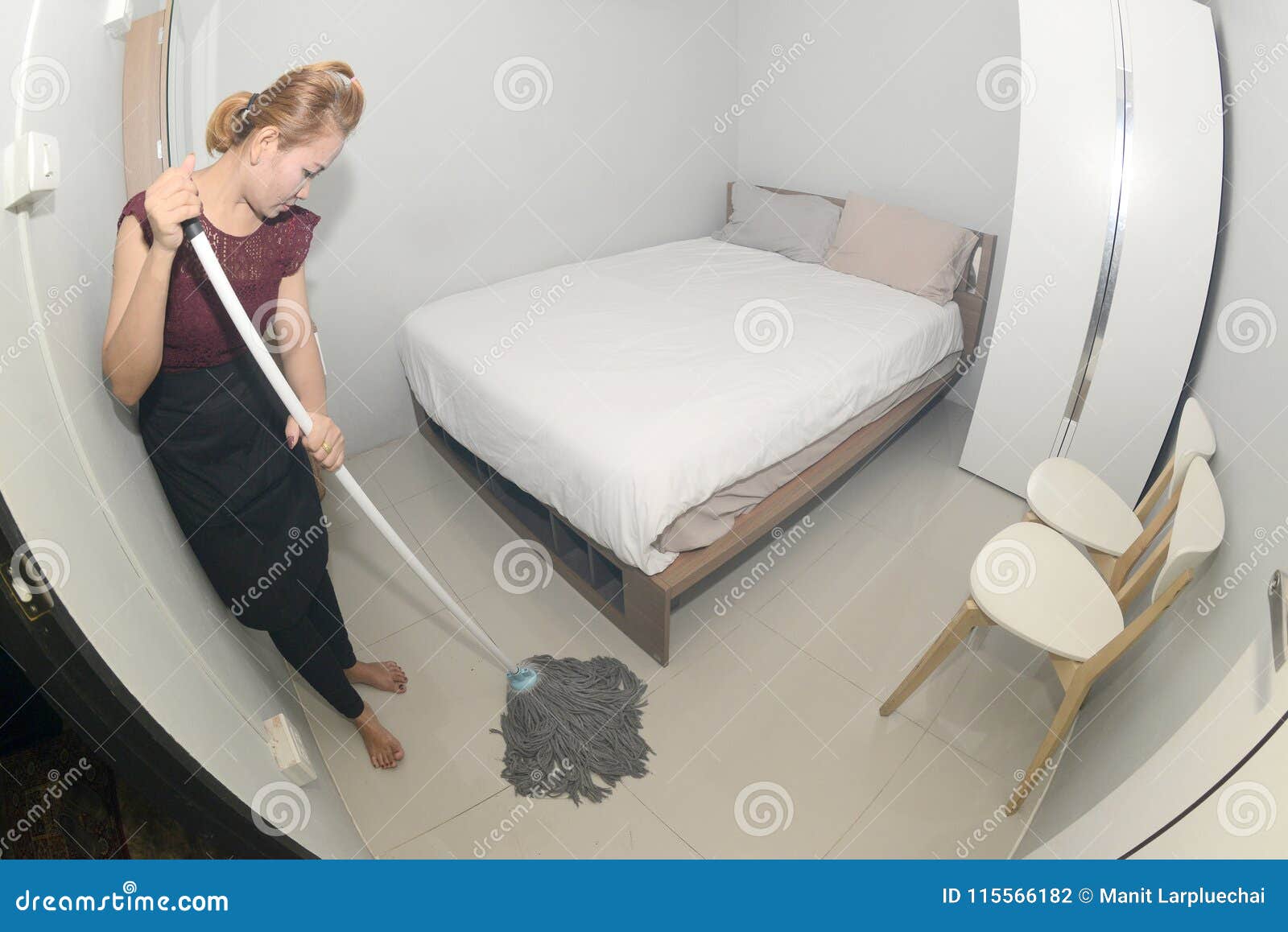 Asian Maid Cleaning Service With Mop Cleaning Floor On A Bedroom