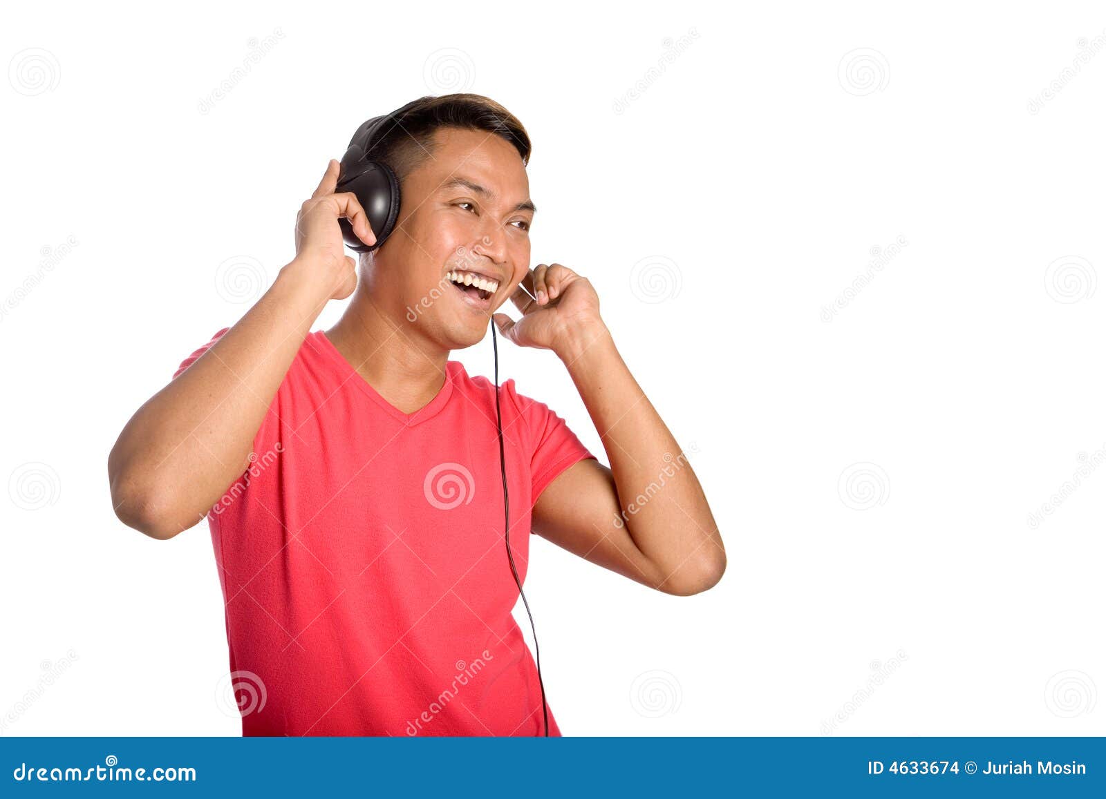 asian man dances as he listens to his headphones.