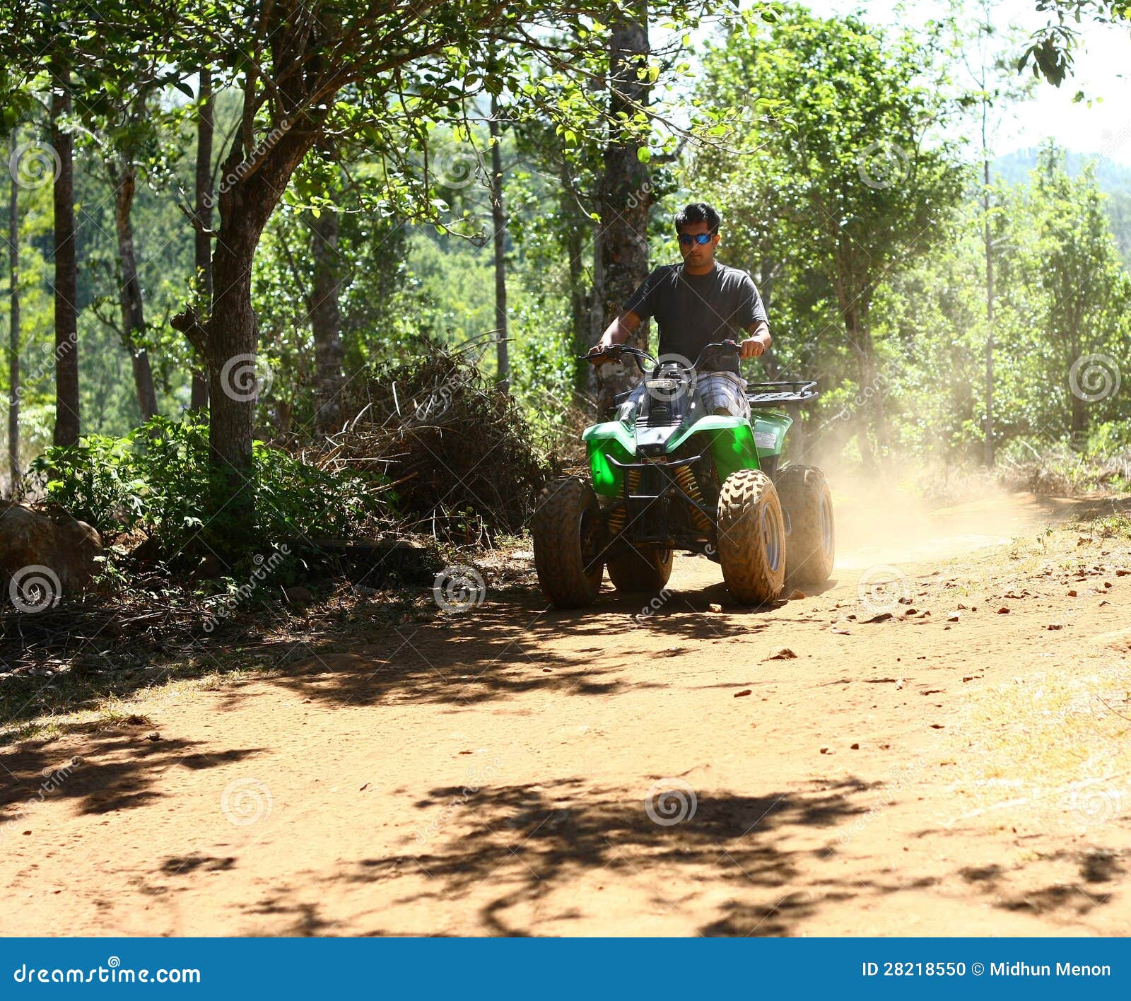 asian man driving all-terrain vehicle on jungle