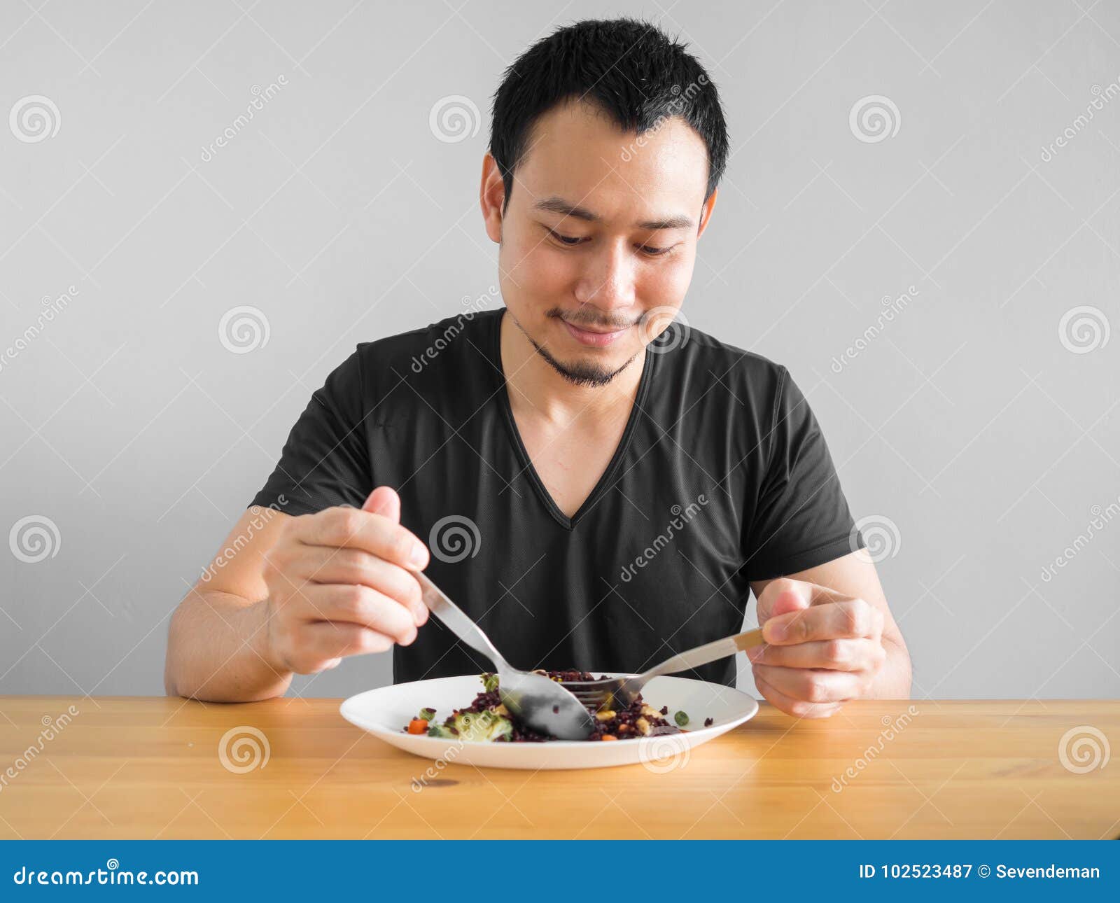 Man eats healthy food. stock image. Image of smiling - 102523487