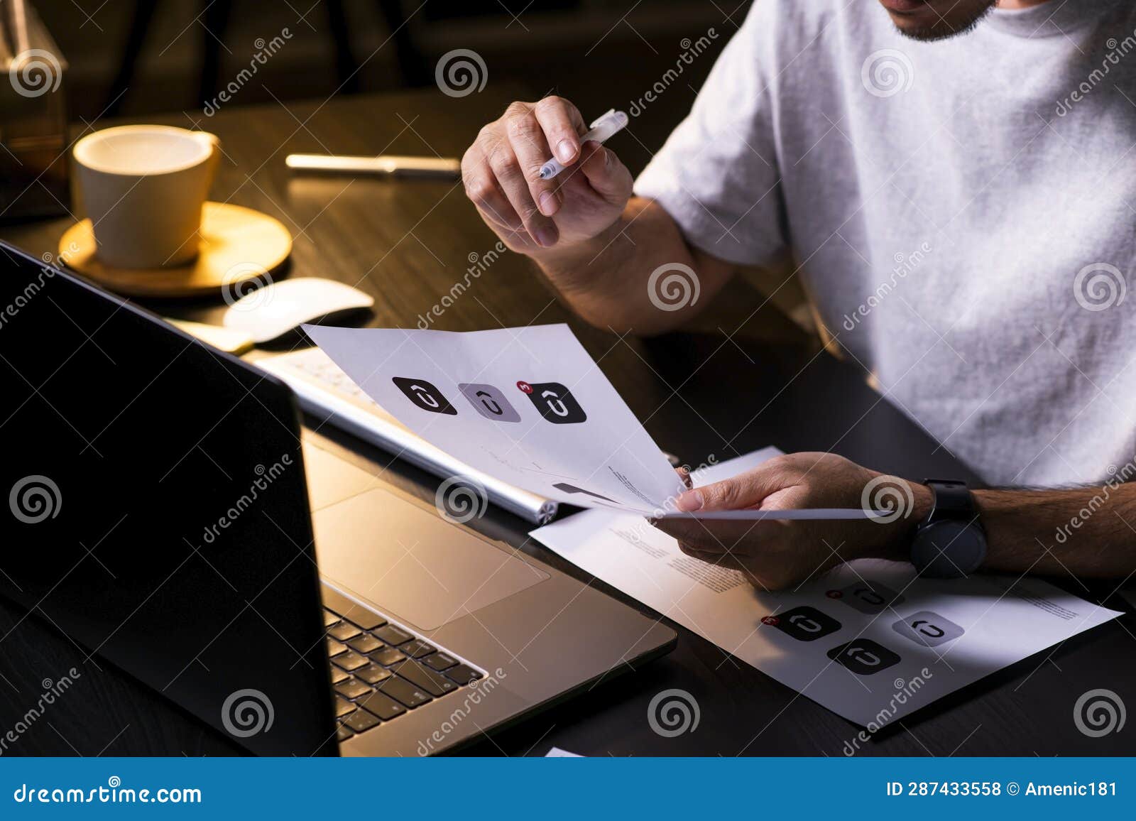 asian man graphic er working on computer drawing sketches logo .
