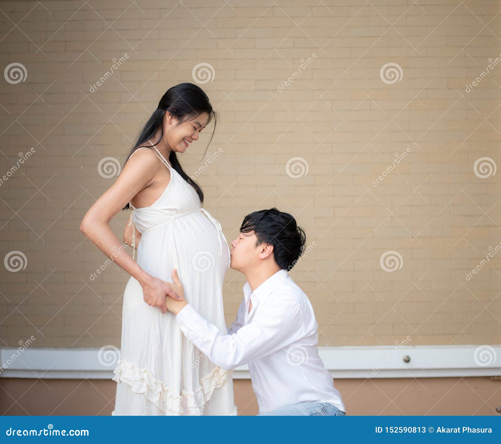 Asian Man Kissing His 9 Month Pregnant Wife`s Belly Stock Image Image Of Home Background 