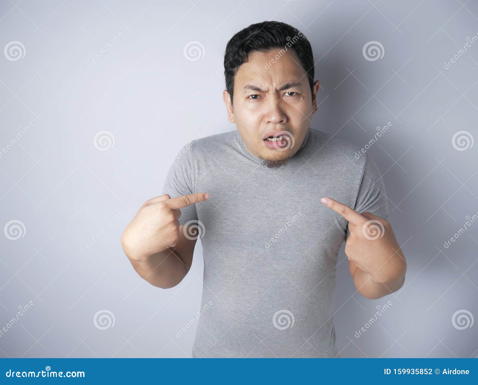 asian man pointing himself with unhappy expression as if he confused to be accused