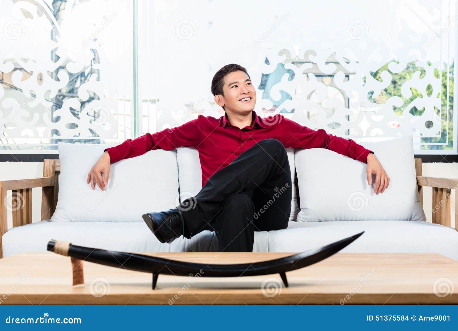 Asian Man Sitting On Sofa In Furniture Store Stock Photo Image