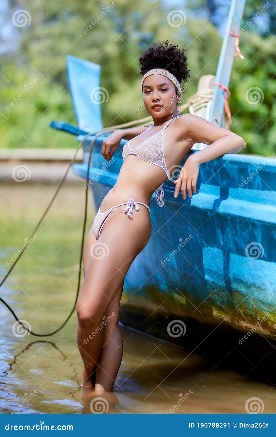 Asian Model in Bikini Posing with Old Fishing Boat Stock Image