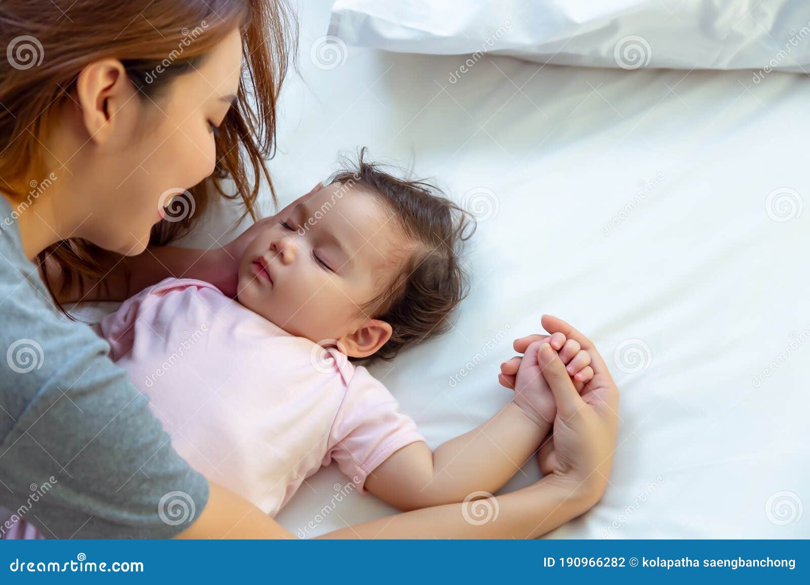 asian mother lull kid, adopt little girl to be her protege or daughter single mother admire with love, fondness of caucasian